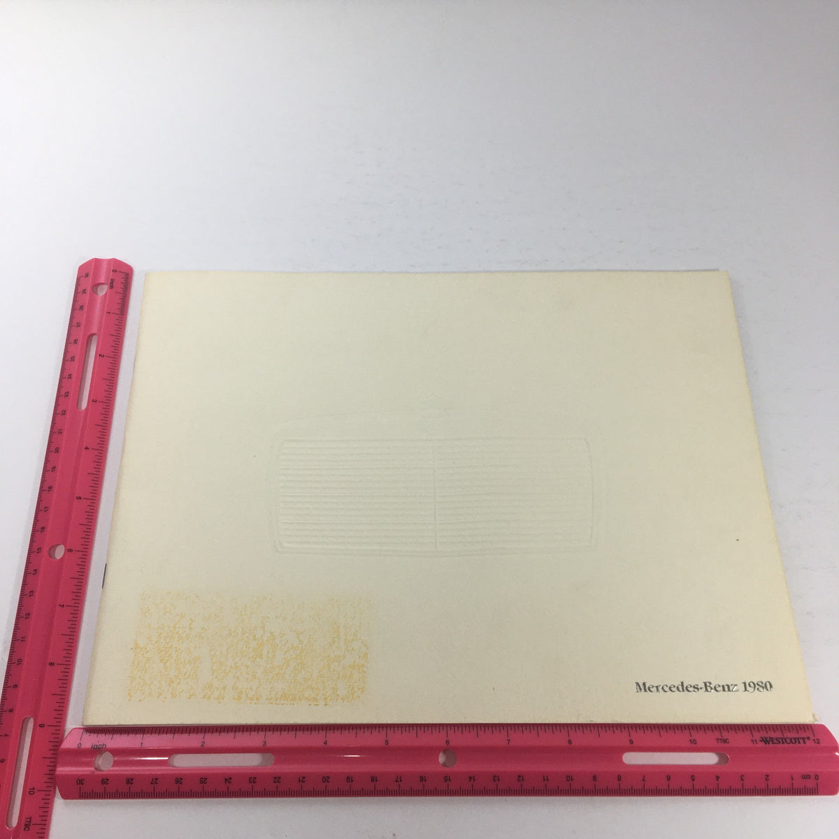 Inside back cover of the 1980 Mercedes-Benz 280CE Dealership Car Auto Brochure Catalog, highlighting embossed design with the Mercedes-Benz branding and a ruler for scale.