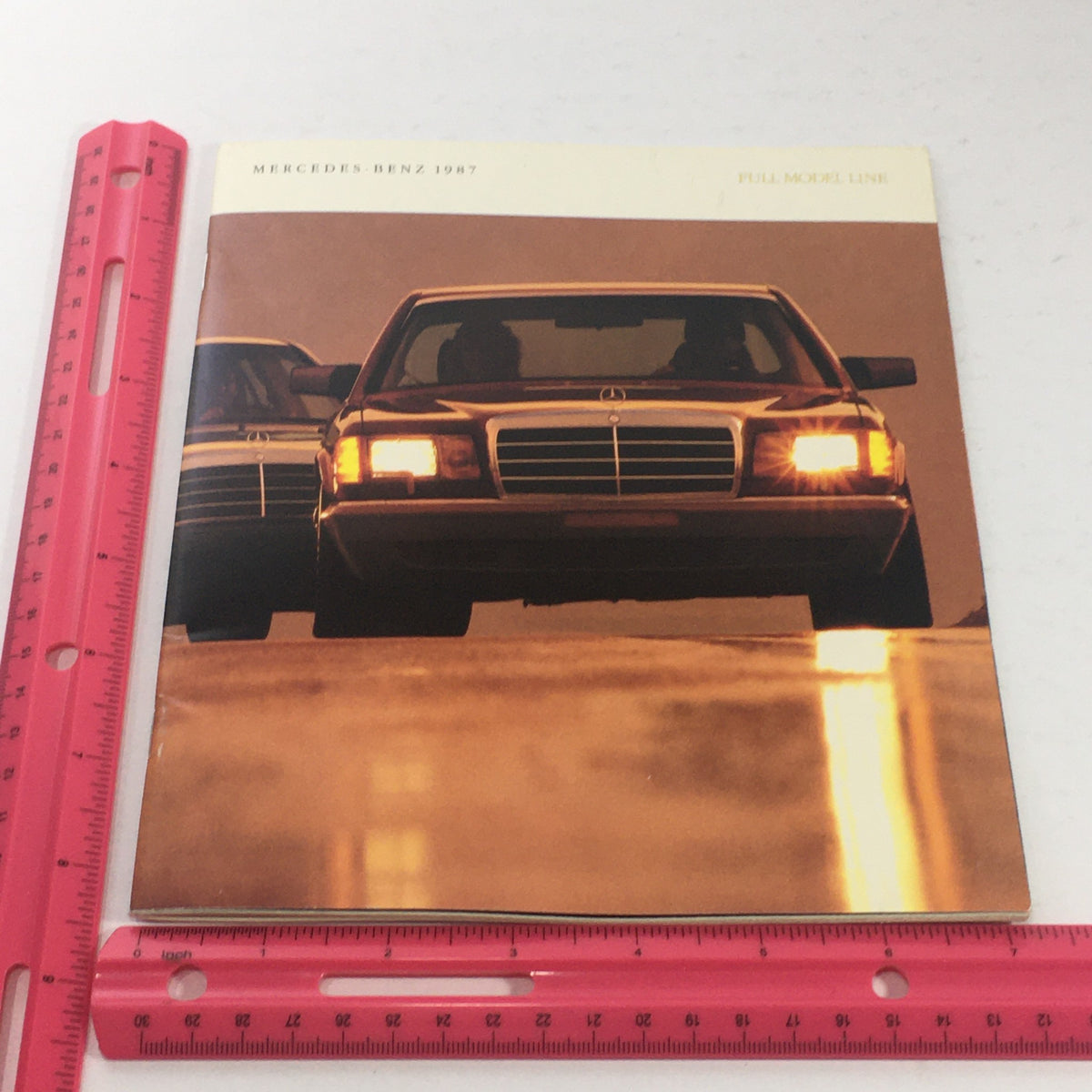 1987 Mercedes-Benz Full Model Line Dealership Car Auto Brochure Catalog with a close-up of two Mercedes cars, highlighting their design.