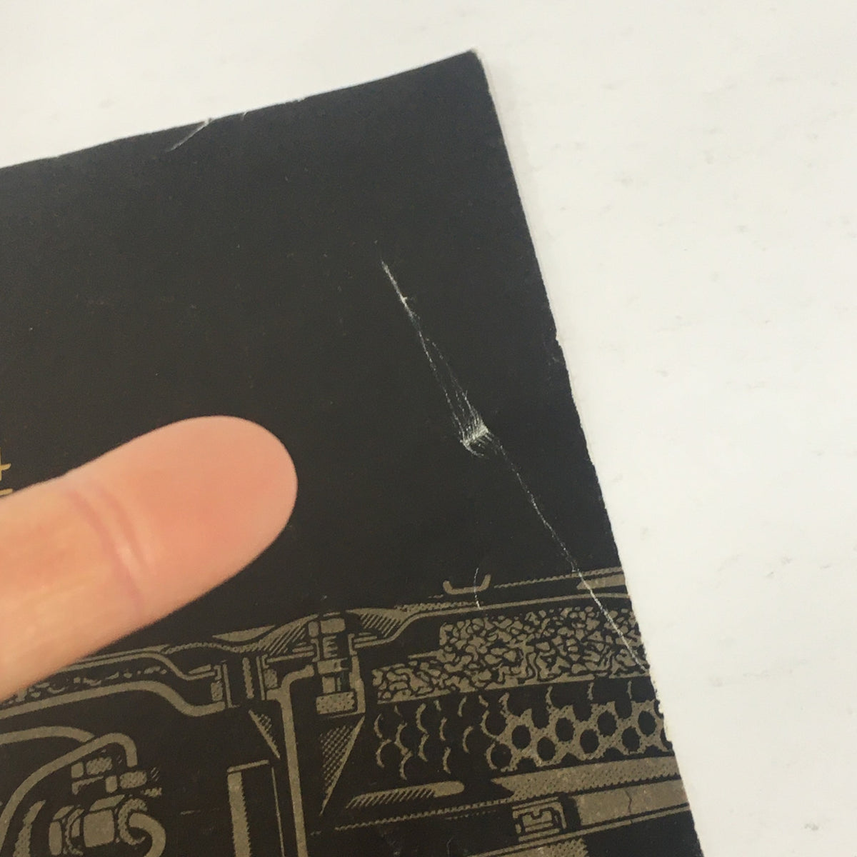 Detailed view of the wear on the cover of the 1984 Mercedes-Benz Specifications Features Dealership Car Auto Brochure Catalog.