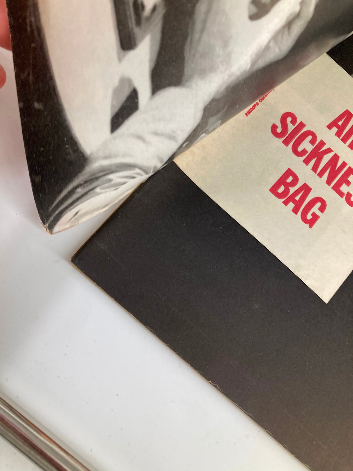 Interior detail of VTG Help Magazine from November 1960, featuring black and white imagery and an air sickness bag, showcasing vintage magazine design.