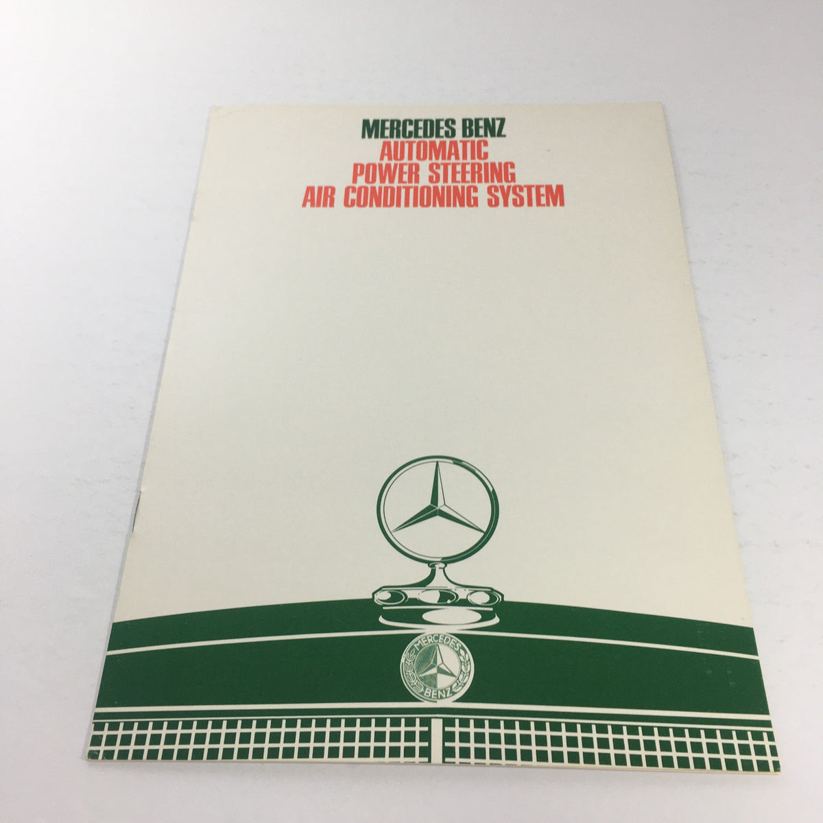 1980s Mercedes-Benz AT/Power Steering Dealership Car Auto Brochure Catalog cover showing the iconic Mercedes-Benz logo and design.