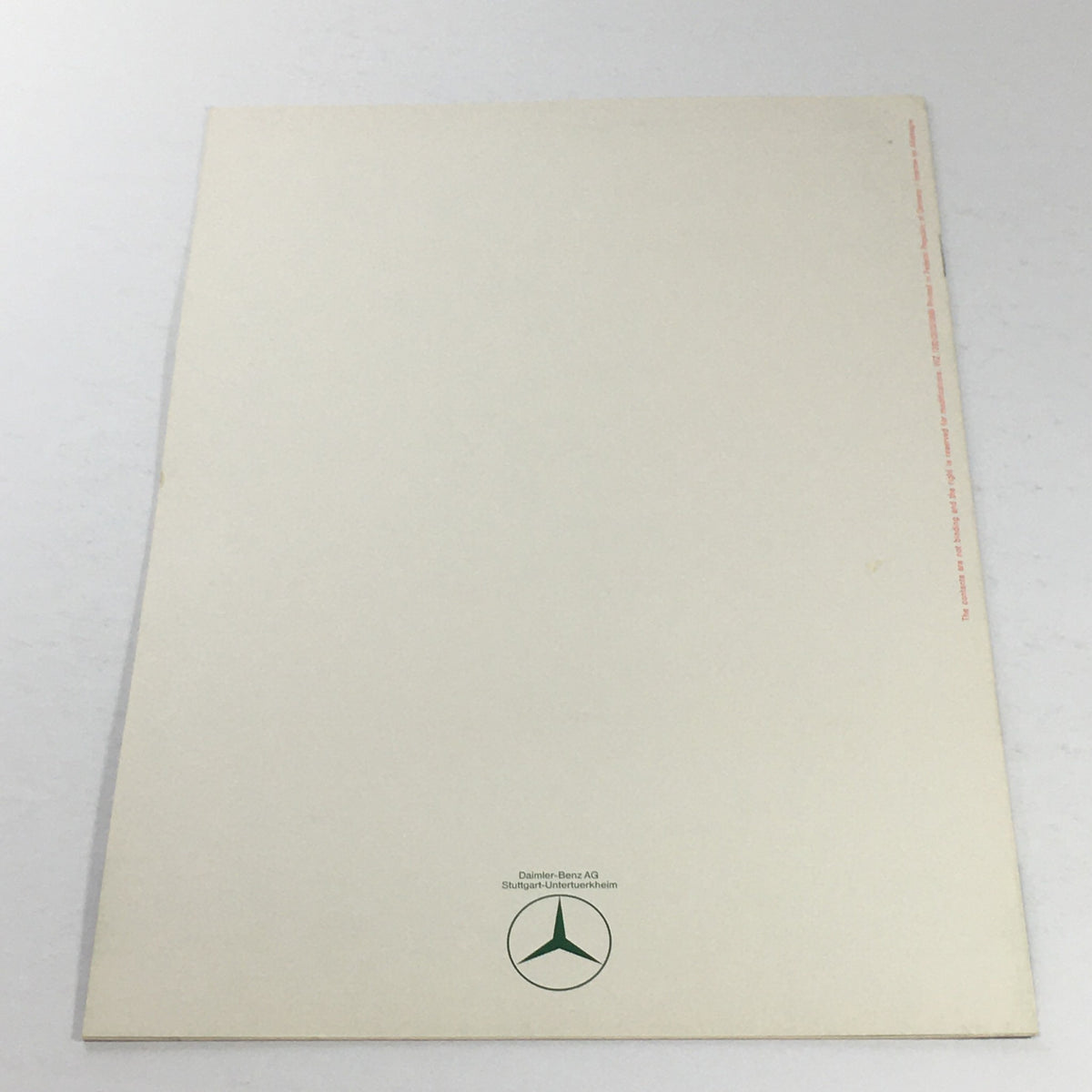 Back cover of the 1980s Mercedes-Benz AT/Power Steering Dealership Car Auto Brochure Catalog showing a clean white design with the Mercedes-Benz logo.