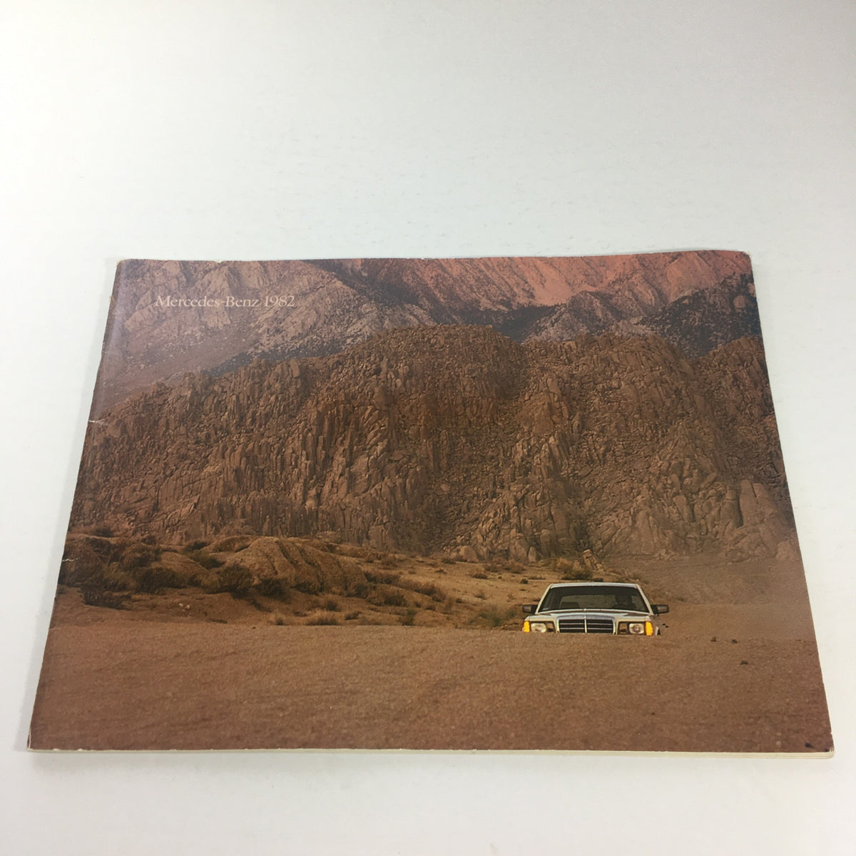 1982 Mercedes-Benz 300-Turbodiesel Dealership Car Auto Brochure Cover featuring a Mercedes vehicle against a mountainous backdrop.