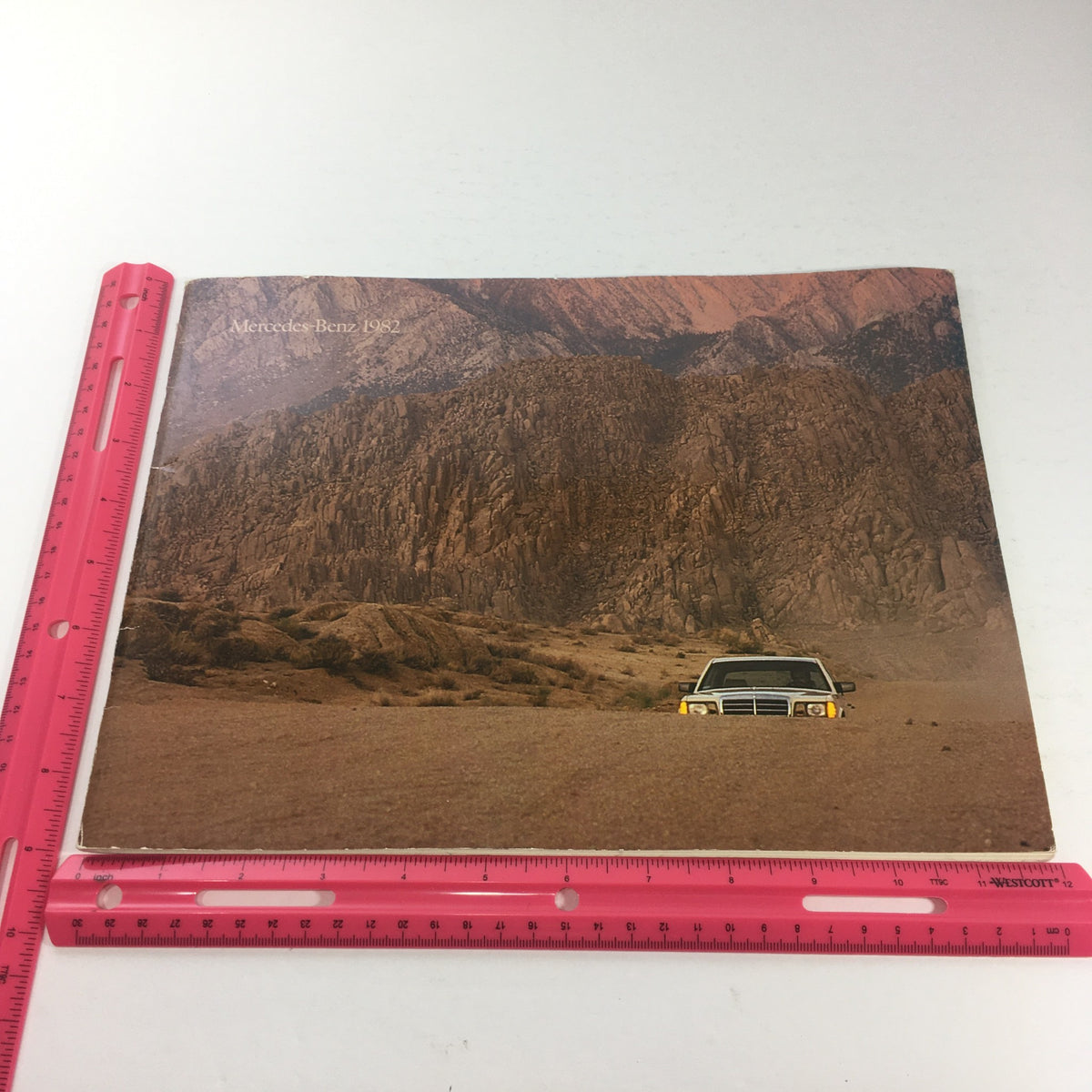 Front cover of the 1982 Mercedes-Benz 300-Turbodiesel Dealership Car Auto Brochure Catalog, depicting a Mercedes-Benz vehicle in a desert landscape, highlighting the brand's rugged capabilities.