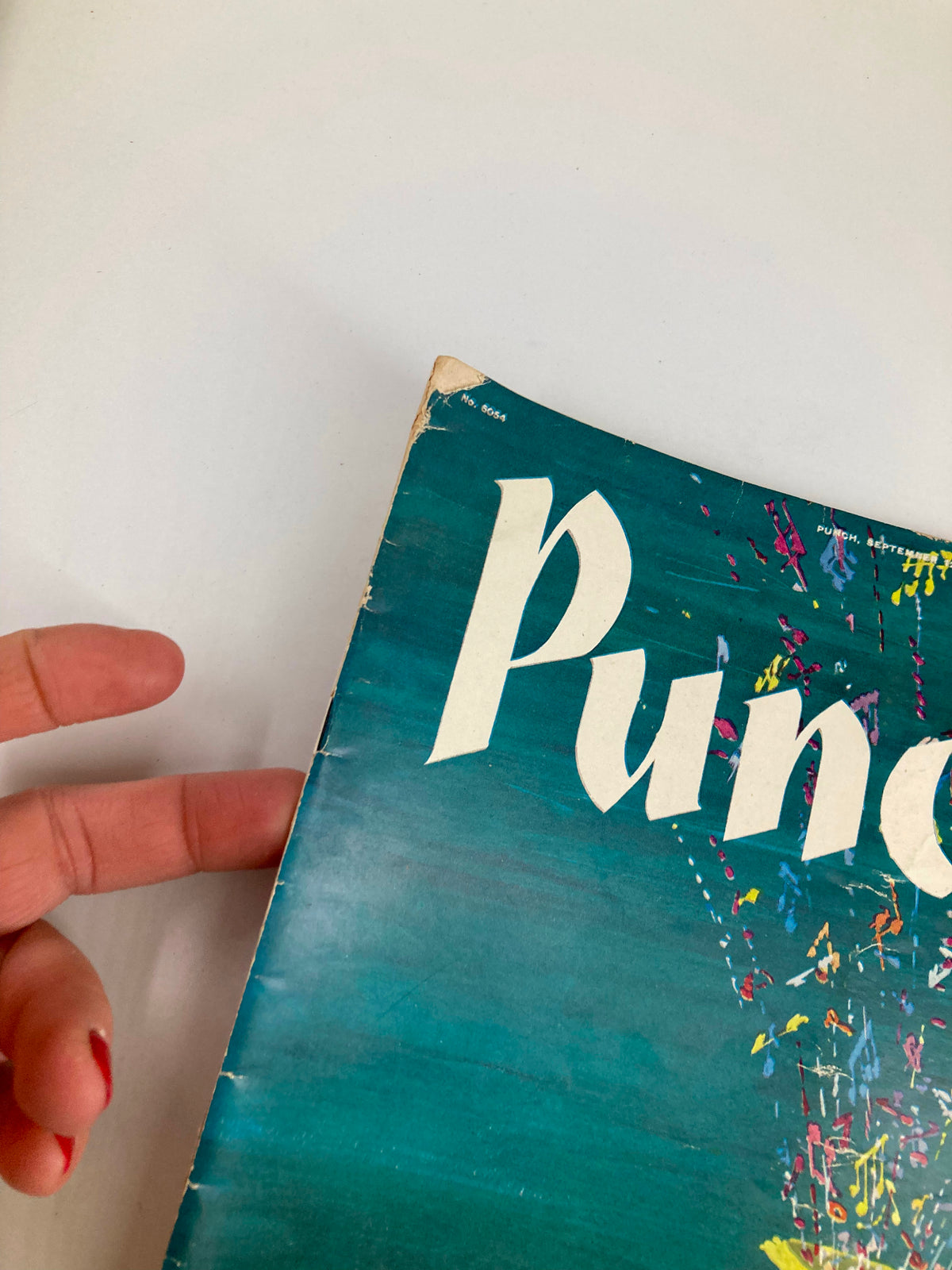 Detail view of the top corner of VTG Punch Magazine September 12 1956 showcasing the vibrant color scheme and the magazine title.