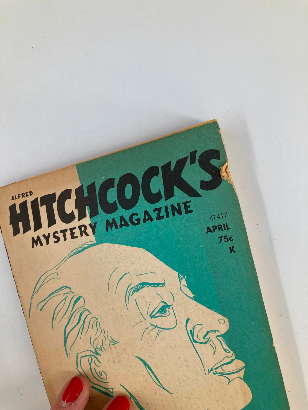Close-up of the cover of Alfred Hitchcock's Mystery Magazine, April 1973, showcasing the iconic lettering and Hitchcock's illustration.