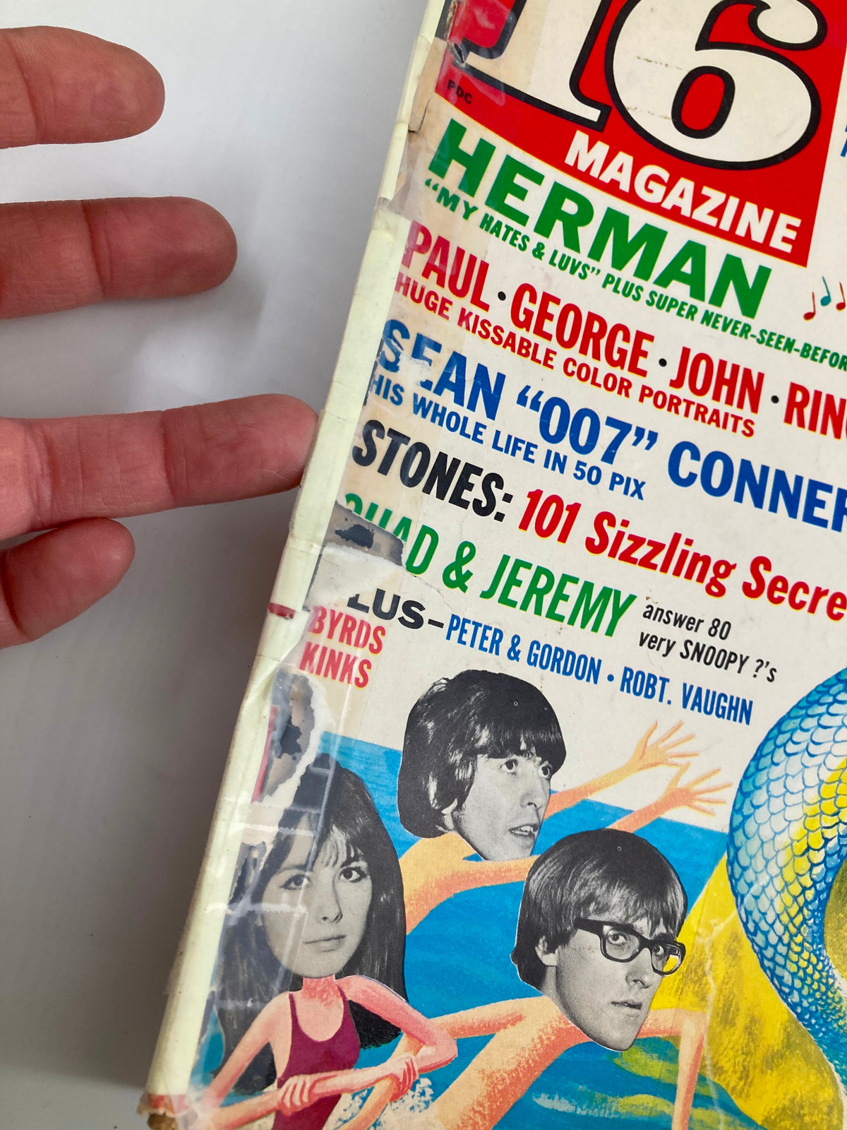 Close-up of the side of VTG 16 Magazine October 1965 showing details of the magazine's cover with portraits of The Beatles, highlighting sections on Paul, George, John, and Ringo, along with additional features.