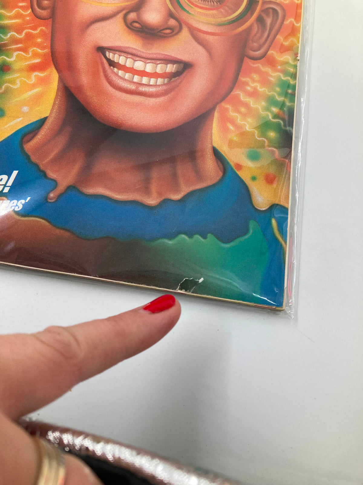 GamePro Magazine December 1989 showing a close-up of the magazine cover indicating minor wear, with a finger pointing to a small defect.