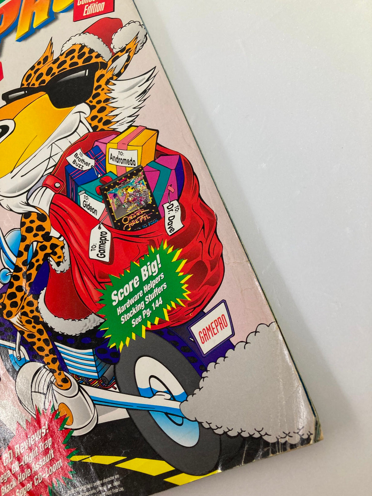 Cover detail of GamePro Magazine Vol 4 #12 featuring Chester Cheetah dressed in holiday attire, showcasing gaming-related gifts and advertisements.