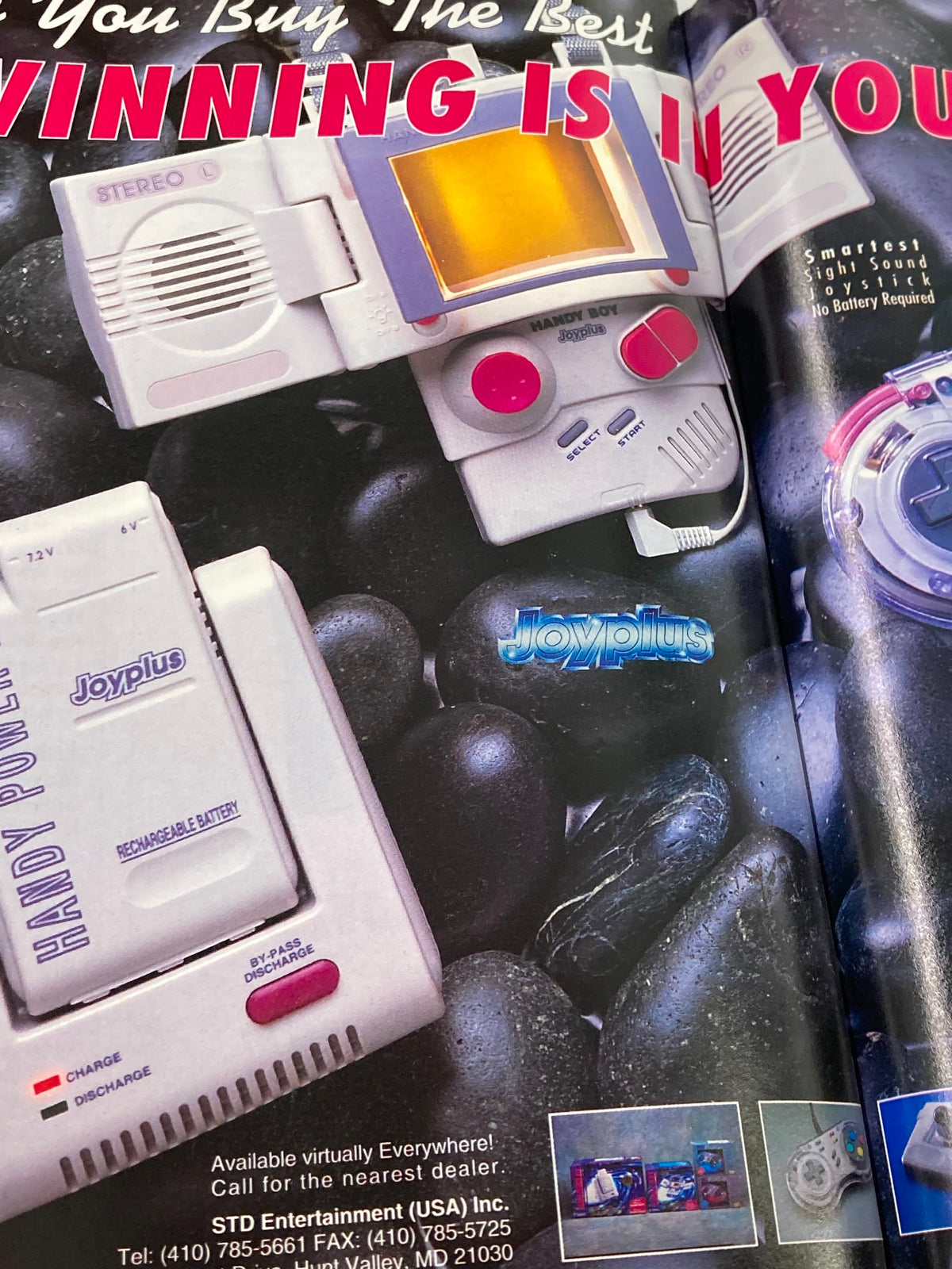 GamePro Magazine Vol 4 #11 presents Joyplus handheld gaming devices and accessories, featuring innovative designs and battery-free operation in a visually appealing advertisement.