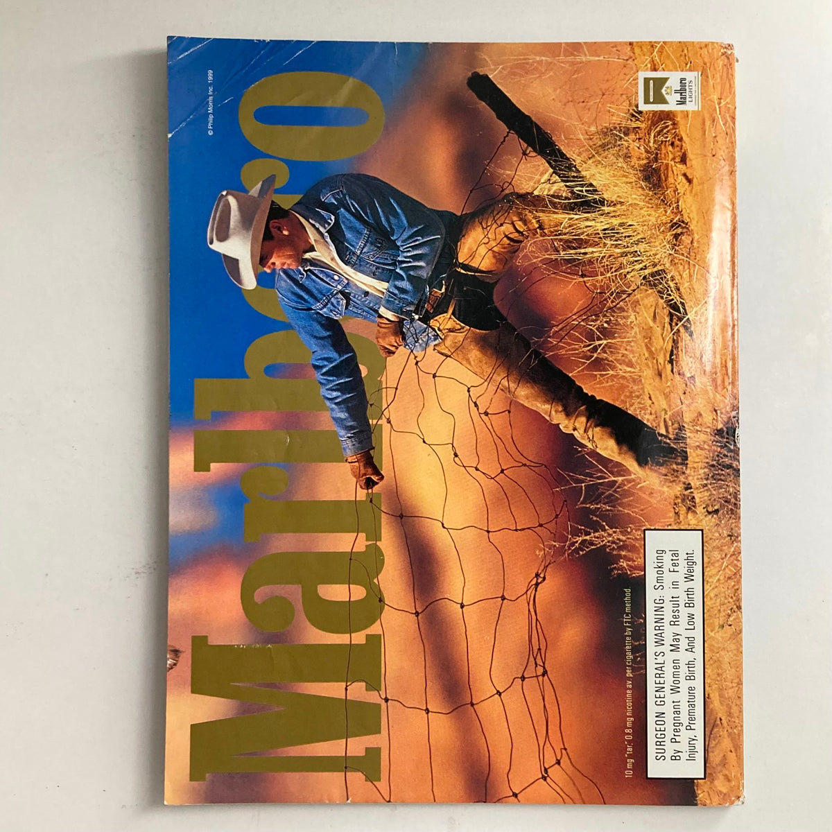 Marlboro advertisement showing a cowboy in denim, juxtaposed to the aesthetic of the Playboy Magazine September 1999 edition.
