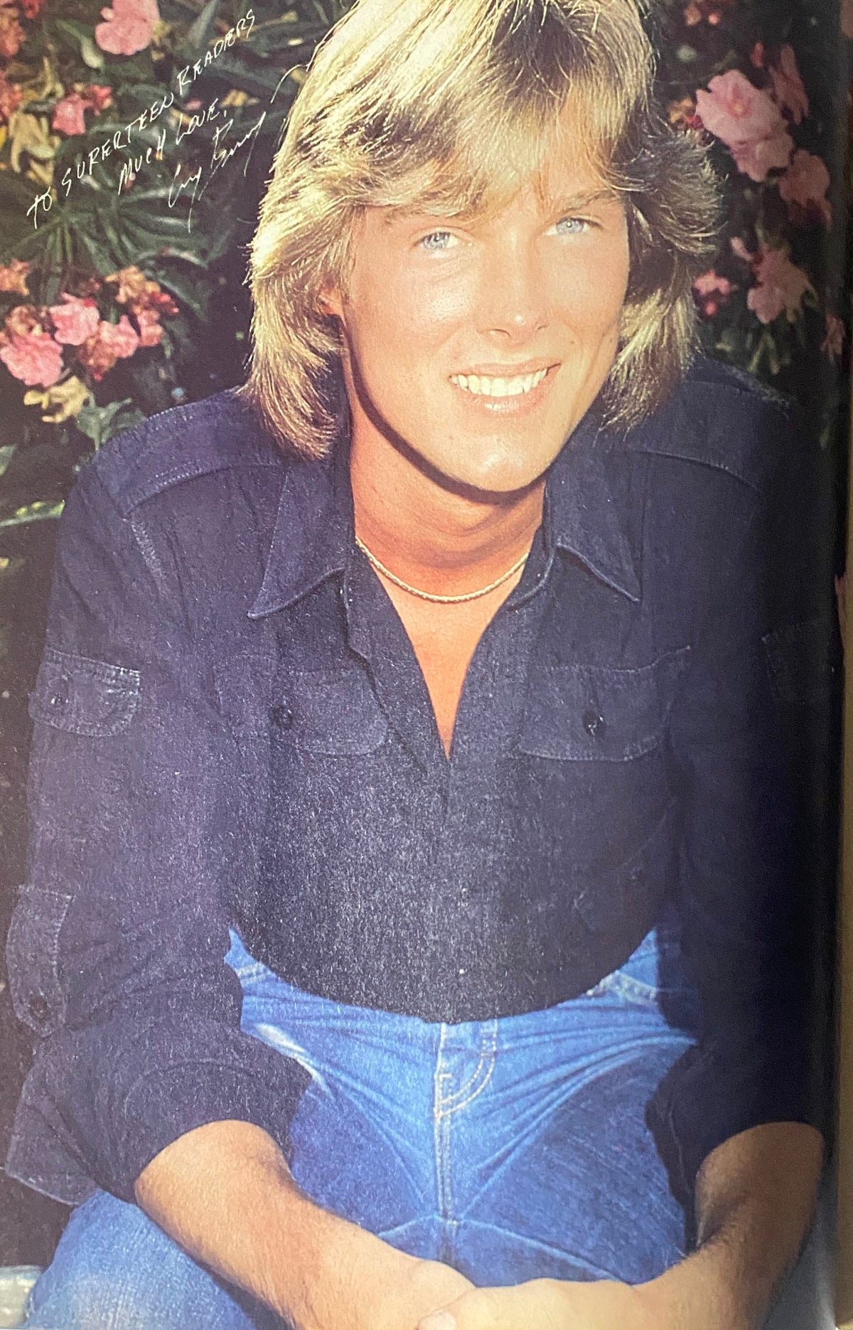 Full-page image of a smiling male star from the SuperTeen Magazine May 1981, posing amidst a floral backdrop.