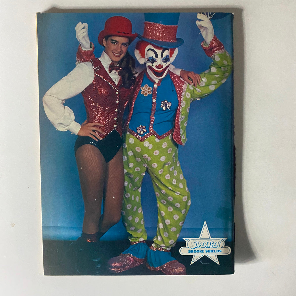 Image of Brooke Shields alongside a clown from SuperTeen Magazine March 1982, showcasing her playful side.
