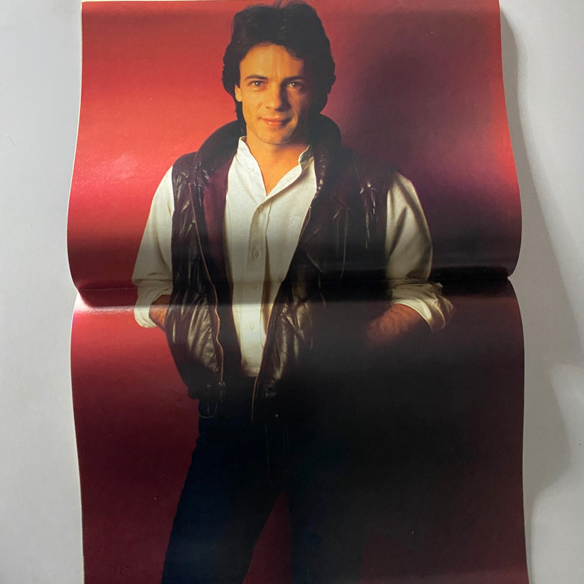 Teen Bag Magazine May 1982 promotional poster of Rick Springfield, showcasing his iconic look with a stylish leather vest against a vibrant background.