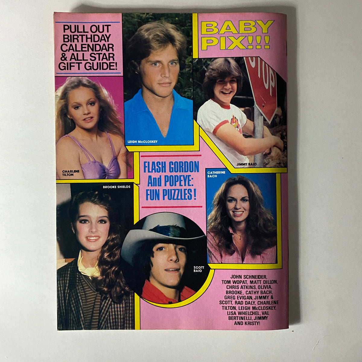 Teen Stars Photo Album Issue No. 5 featuring John Schneider, Olivia Newton-John, and other 1980s celebrities with colorful pinups, quizzes, and fun extras. The cover includes images of Leigh McCloskey, Charlen Tilton, Brooke Shields, Jimmy Baio, Scott Baio, and Catherine Bach, along with text highlighting 'Baby Pix!!!' and 'Flash Gordon and Popeye: Fun Puzzles!'. Perfect for fans of 1980s entertainment.