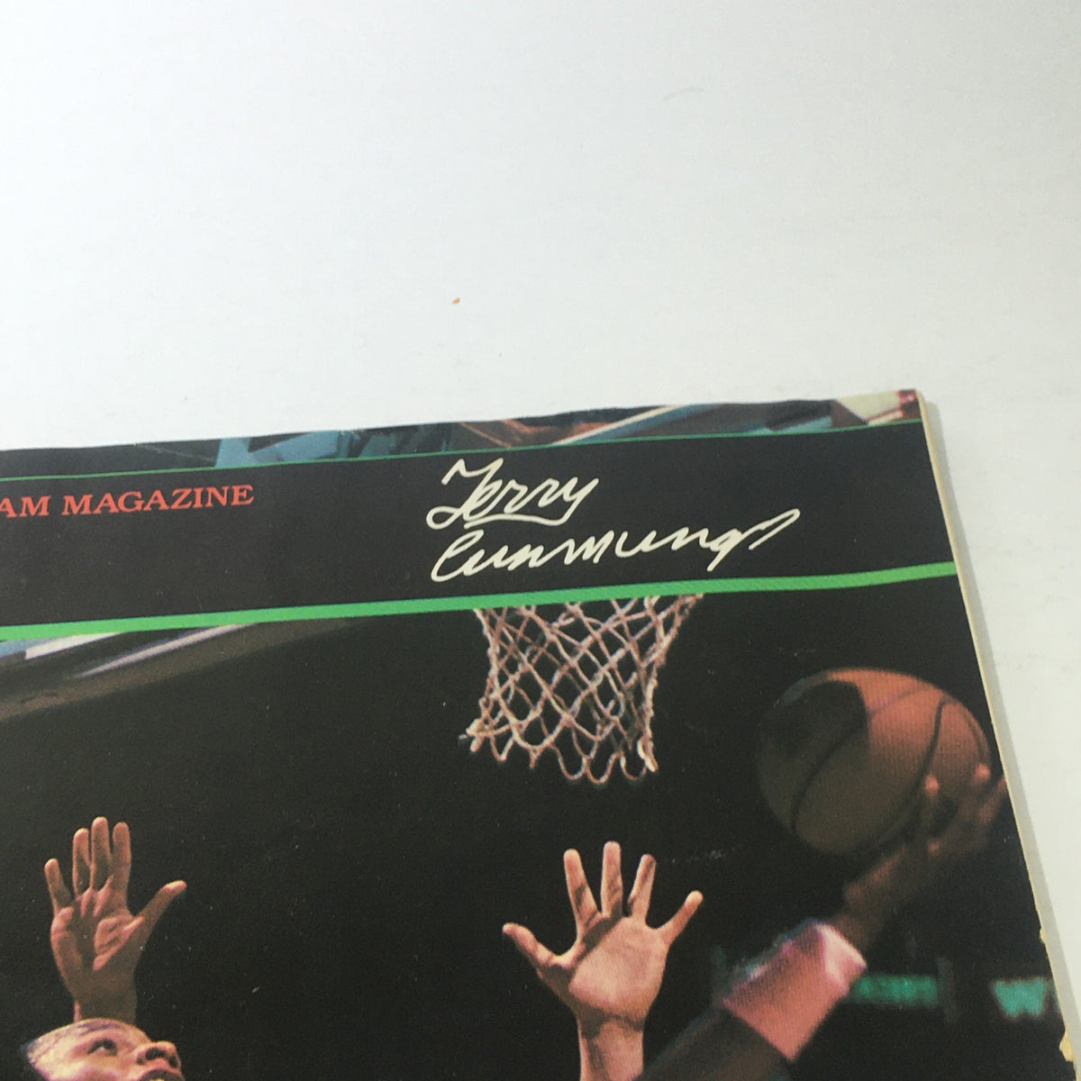 Close-up of the Hoop NBA Magazine cover, highlighting Terry Cummings' signature, capturing an iconic moment from the 1980s.