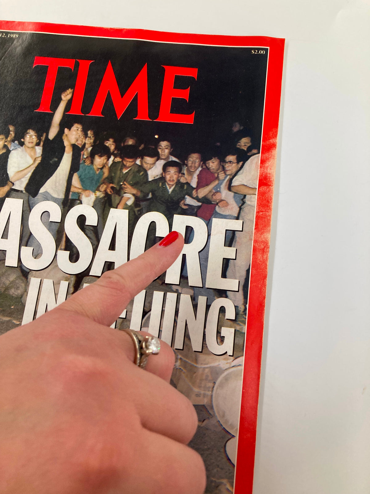 Close-up of the cover of VTG Time Magazine June 12 1989, highlighting the title 'Massacre in Beijing' as a hand points to the text.