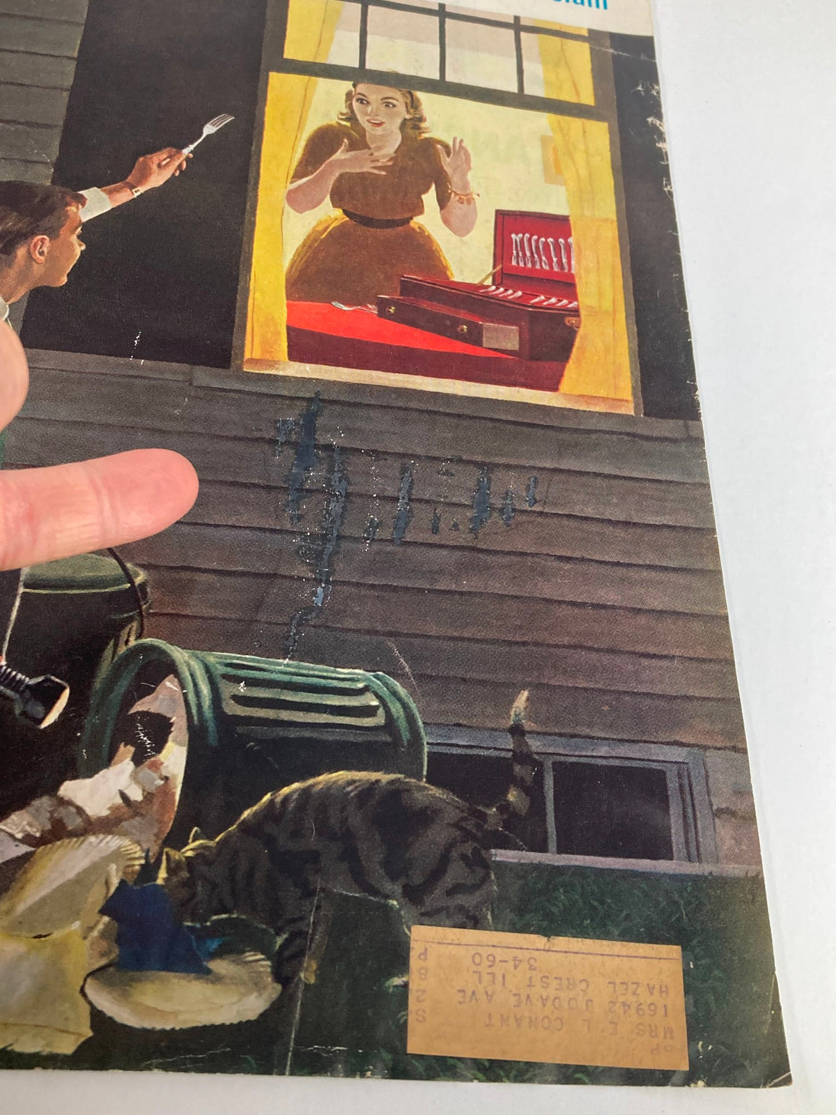 Detailed view of The Saturday Evening Post cover from October 3, 1959, featuring a woman at a window, a man holding a fork outside, and a cat on the ground. This vintage magazine cover highlights classic American culture and vintage aesthetics.