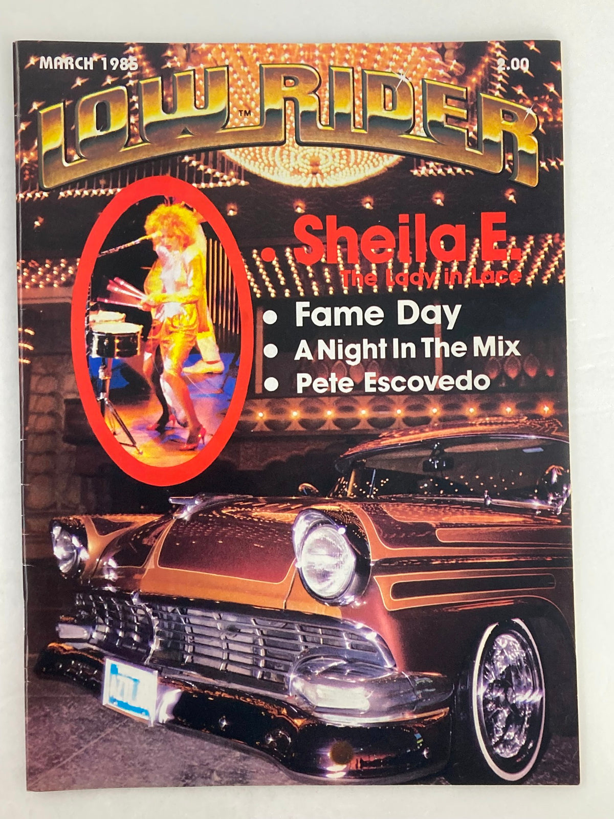 Cover of VTG LowRider Magazine March 1985 featuring Sheila E. as 'The Lady in Lace' with a striking lowrider car and event highlights.