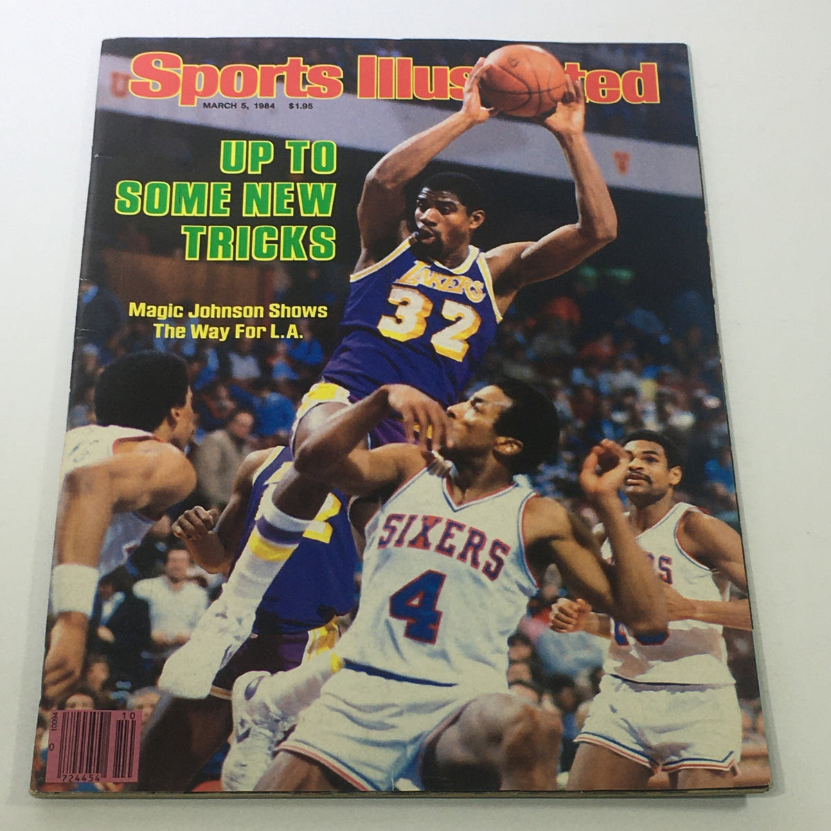 Cover of Sports Illustrated magazine from March 5, 1984, featuring NBA superstar Earvin 'Magic' Johnson in action for the L.A. Lakers, showcasing the headline 'UP TO SOME NEW TRICKS'.