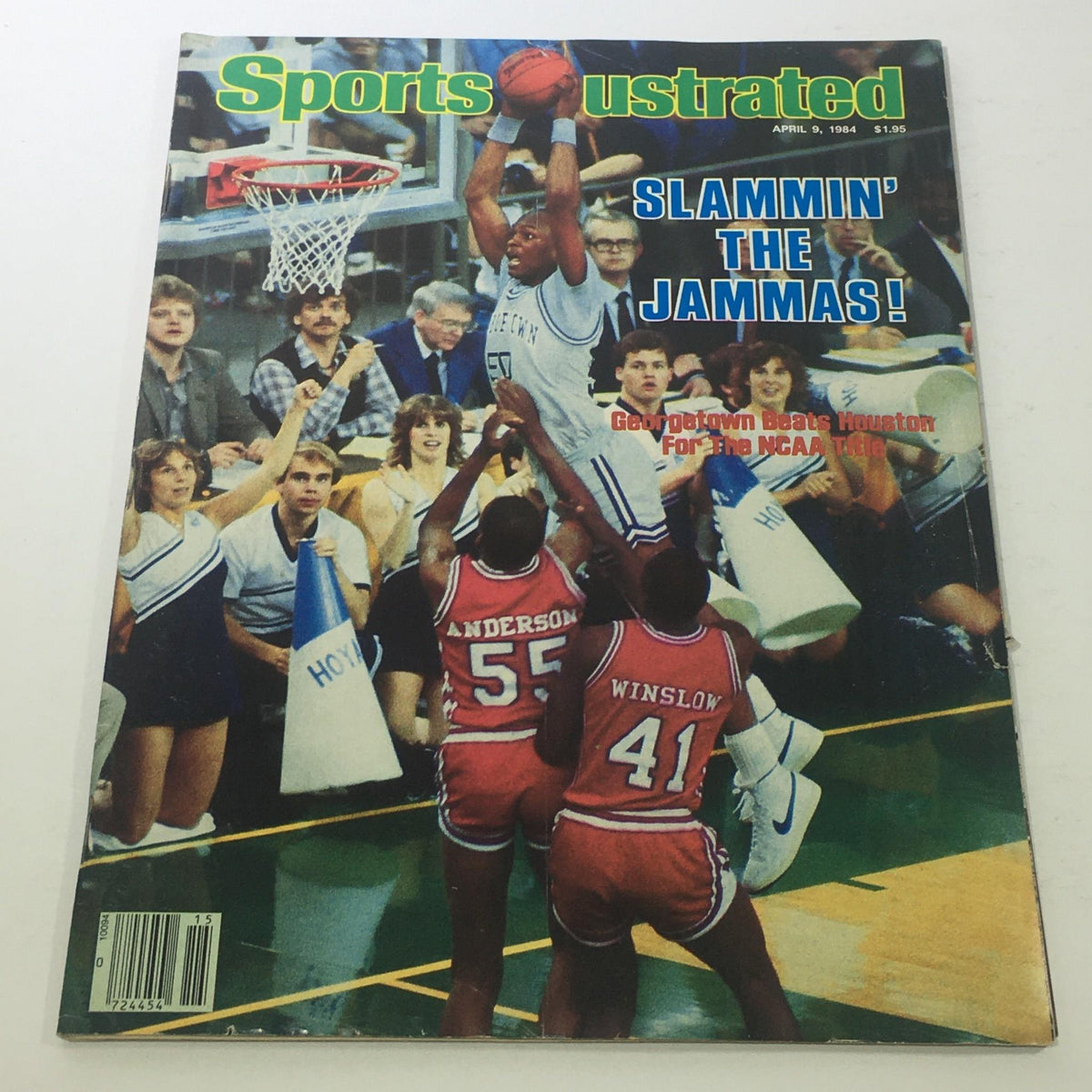 Sports Illustrated cover from April 9, 1984, featuring the headline 'SLAMMIN' THE JAMMAS!' highlighting Georgetown's victory over Houston for the NCAA title, showcasing a basketball player in action during the game.