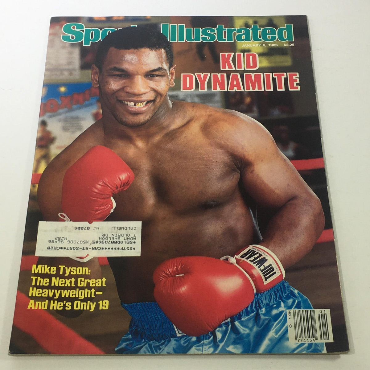Cover of Sports Illustrated magazine from January 6, 1986, featuring Mike Tyson, also known as Kid Dynamite, showcasing his boxing prowess at age 19. The cover highlights Tyson's legacy as a great heavyweight and includes his signature red boxing gloves and blue shorts.