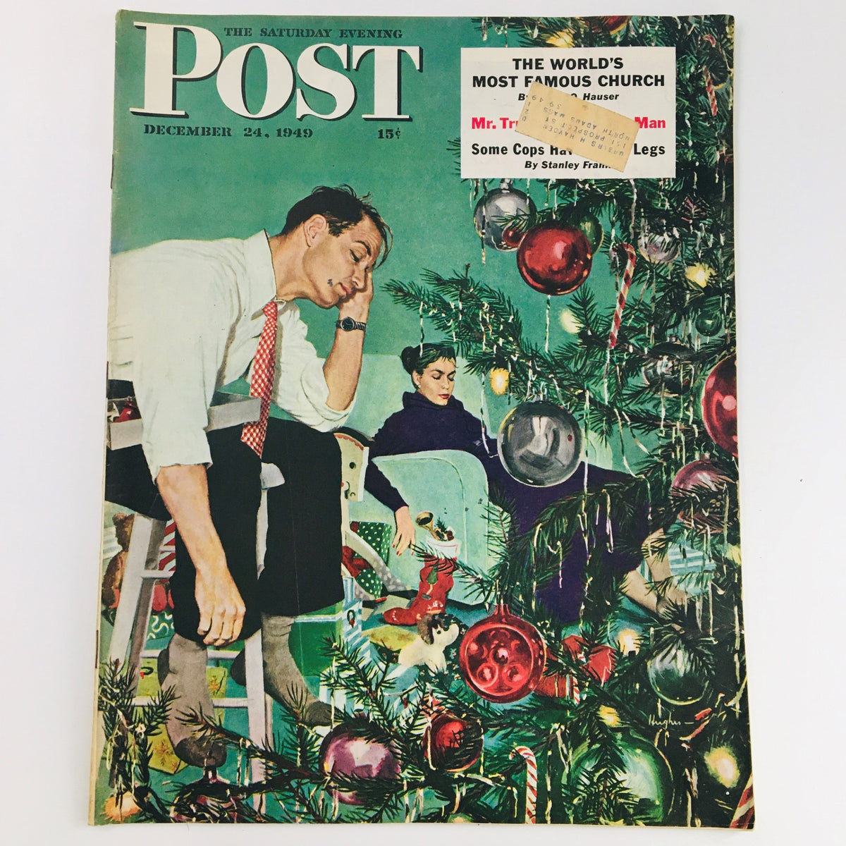 The Saturday Evening Post December 24 1949 cover featuring a Christmas scene with a man and woman surrounded by a Christmas tree and ornaments. This vintage magazine encapsulates post-war American culture.