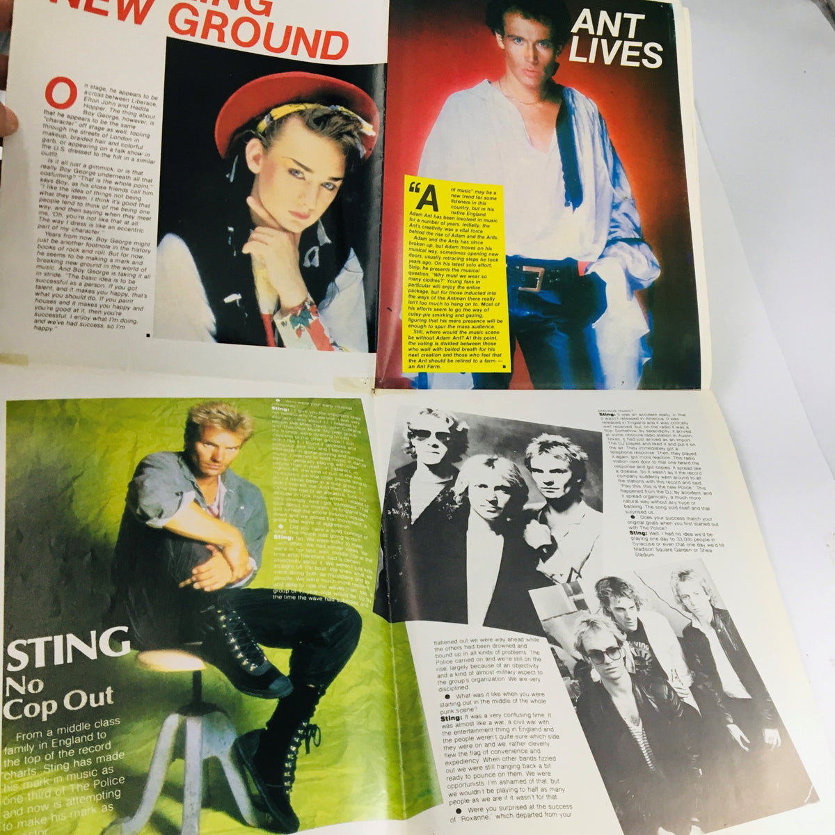 Magazine spread from Pop TV Giants Poster Magazine 1984 featuring articles on popular artists such as Boy George, Adam Ant, and Sting.