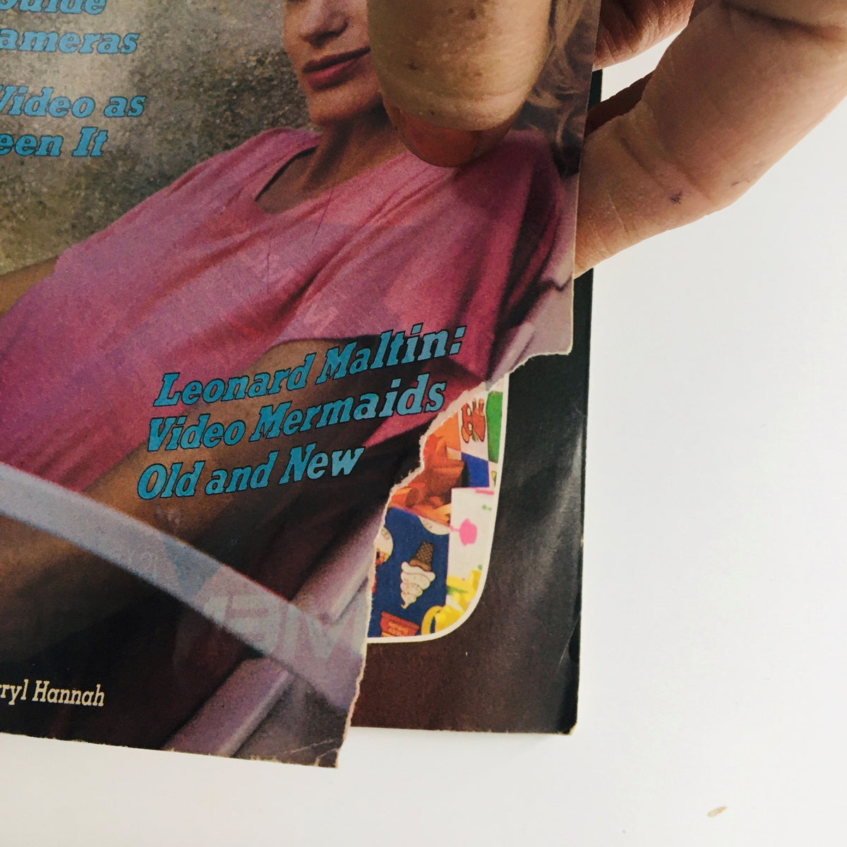 Close-up view of the cover of Video Review Magazine August 1984, emphasizing Daryl Hannah and the article topics such as Leonard Maltin's video mermaids.