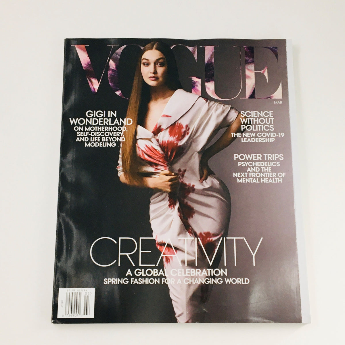Vogue Magazine March 2021 cover featuring Gigi Hadid in a whimsical design titled 'Gigi in Wonderland.' The issue explores 'Science Without Politics,' along with other contemporary topics, highlighting fashion and cultural discourse.