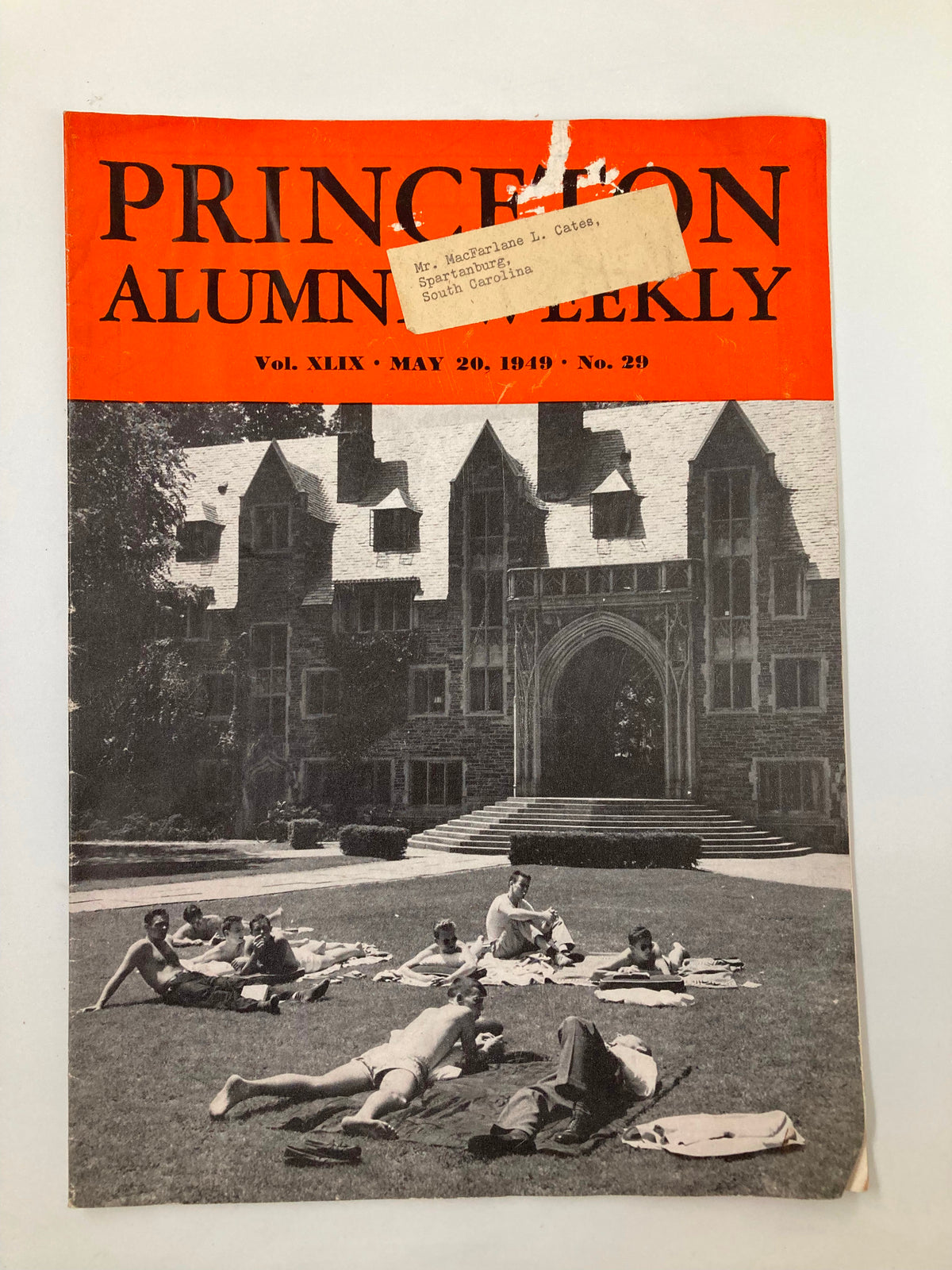 Cover of VTG Princeton Alumni Weekly May 20 1949 featuring a group of students lounging on the grass in front of a Princeton University building.