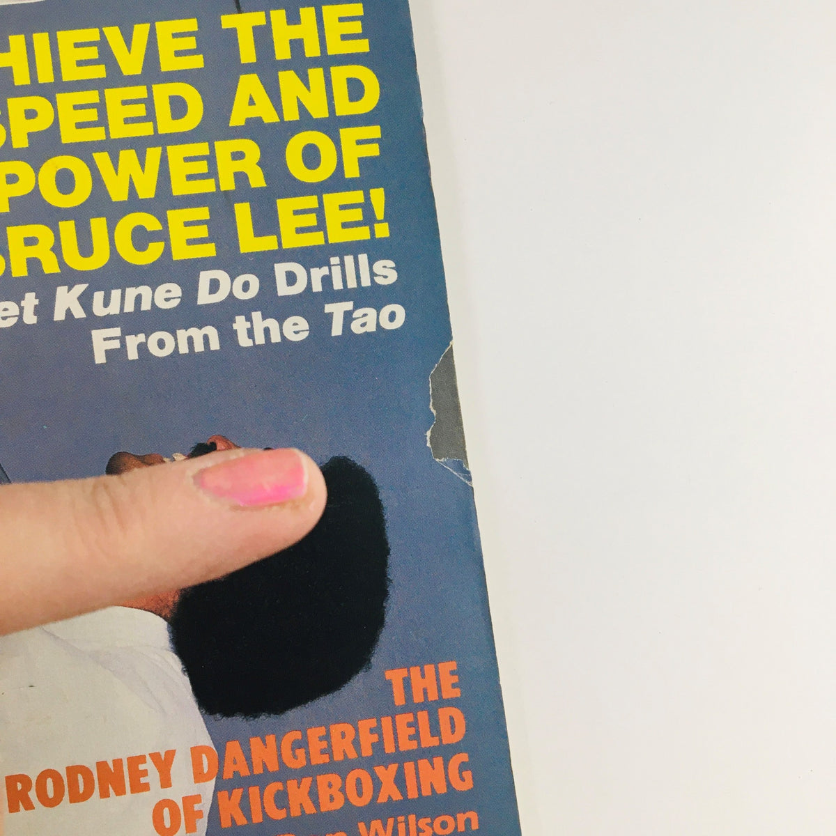 Close-up of Black Belt Magazine June 1989 Vol 27 #6 showing the headline 'Achieve the Speed and Power of Bruce Lee!' and finger pointing at corner damage.