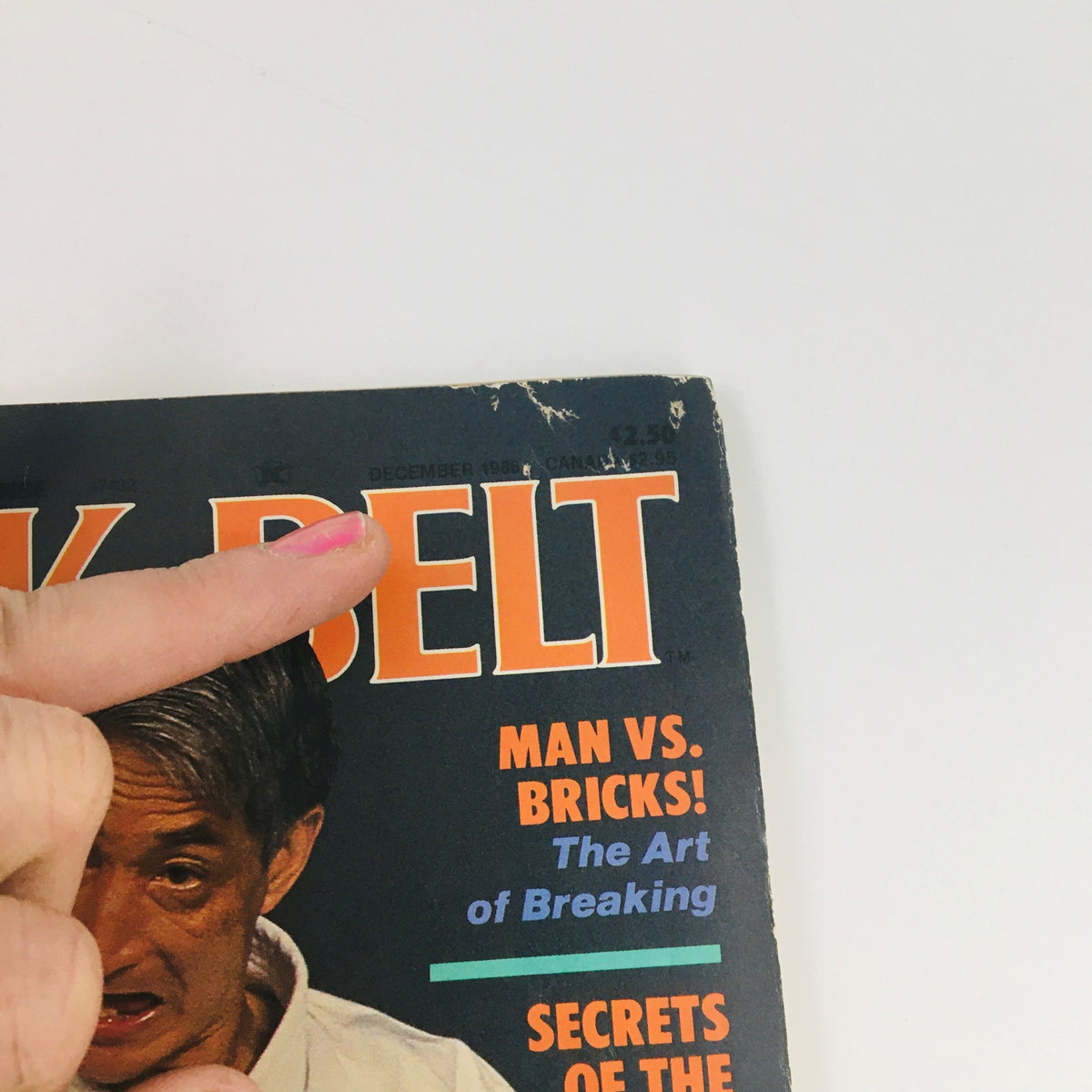 Close-up view of the cover of Black Belt Magazine December 1986 Vol 24 #12 highlighting the magazine title and date, including articles on martial arts techniques and the legendary figure Hidetaka Nishiyama.