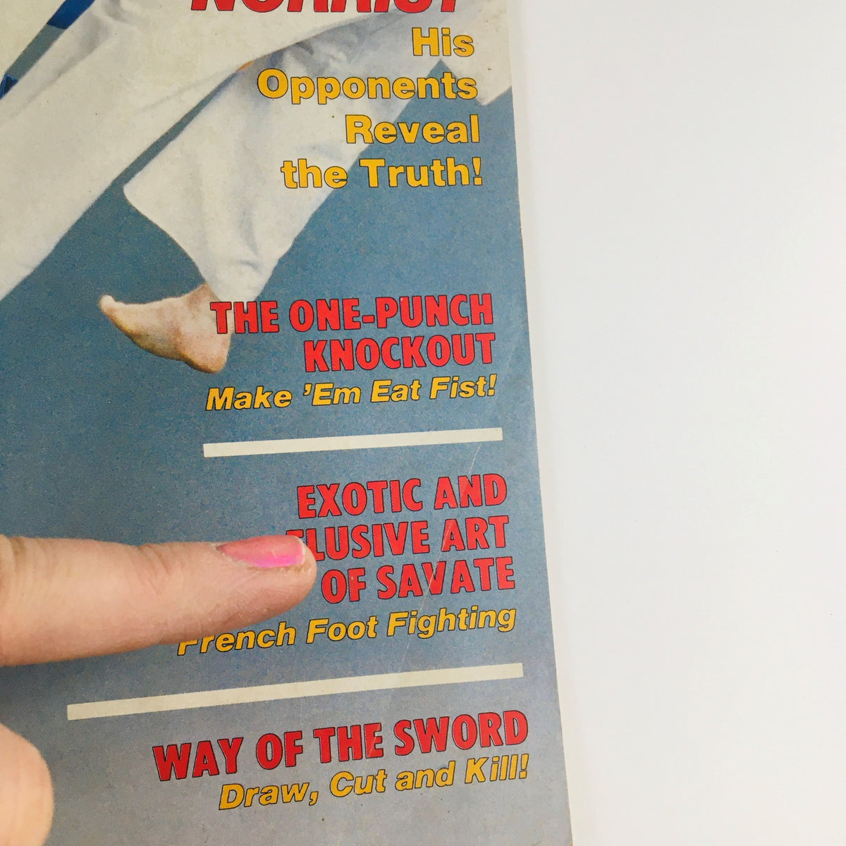 Close-up of the Black Belt Magazine June 1987 cover showing highlights including the One-Punch Knockout and the Exotic Art of Savate, with finger pointing to text.