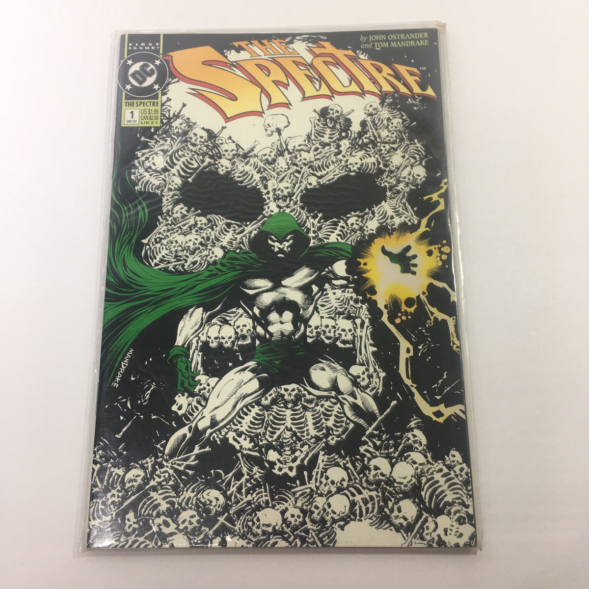 First Issue DC December 1 1992 - The Spectre comic book cover featuring artwork by John Ostrander and Tom Mandrake, showcasing a dramatic skull design with green hooded figure amidst a background of skeletal imagery.