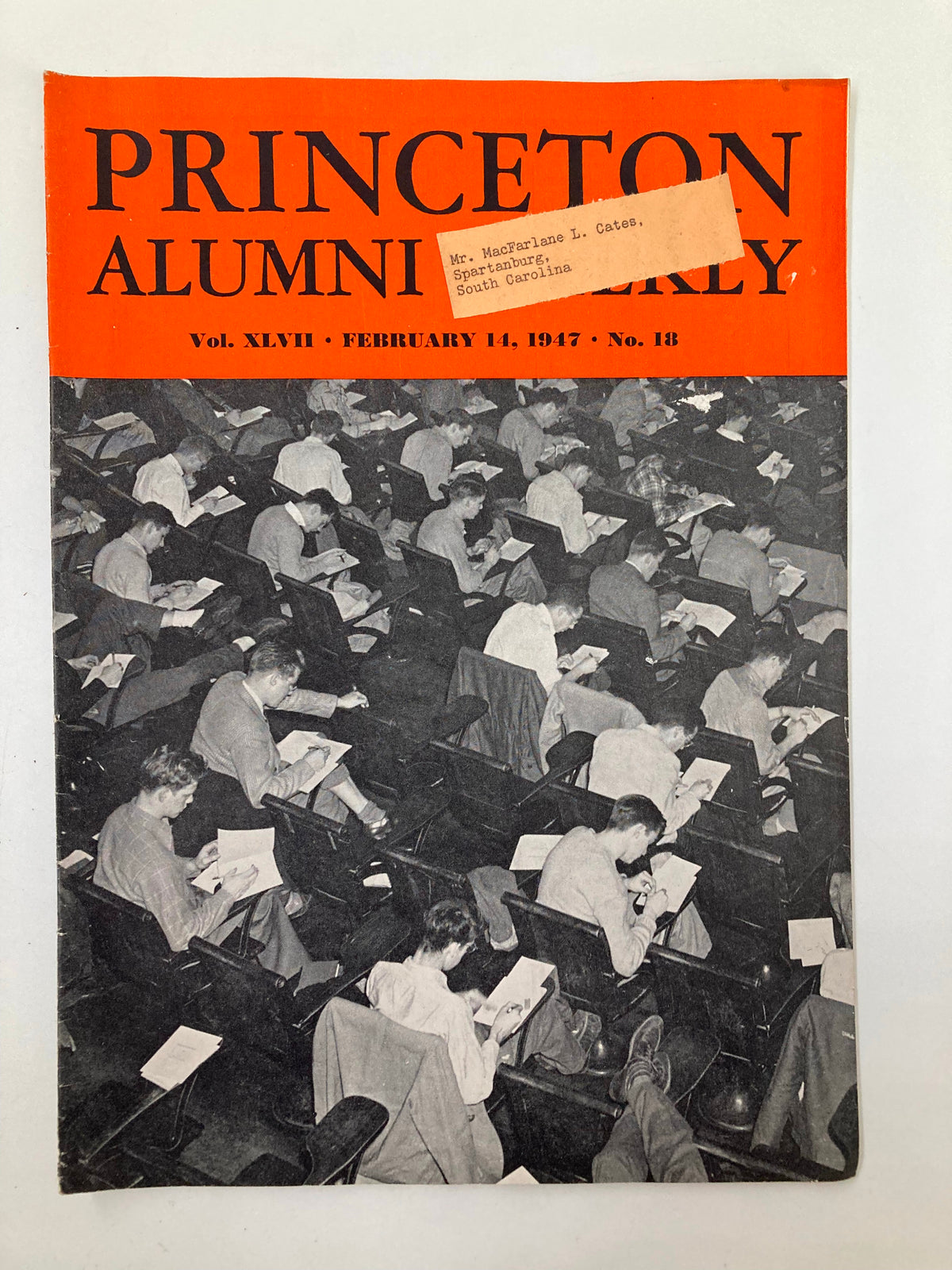 Cover of VTG Princeton Alumni Weekly, February 14, 1947, featuring students in a classroom setting engaged in writing and note-taking, showcasing Princeton University's educational environment.