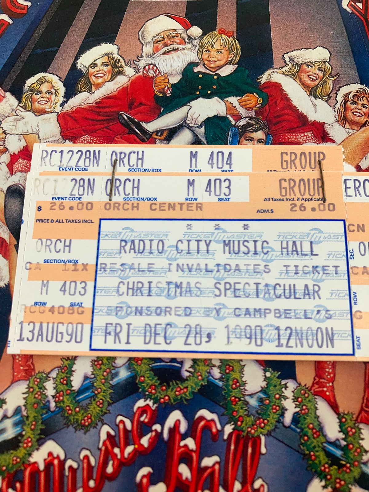1990 Program Radio City Music Hall The Rockettes in Christmas Spectacular, close-up shot of the cover with Santa Claus and children, showing ticket stubs.