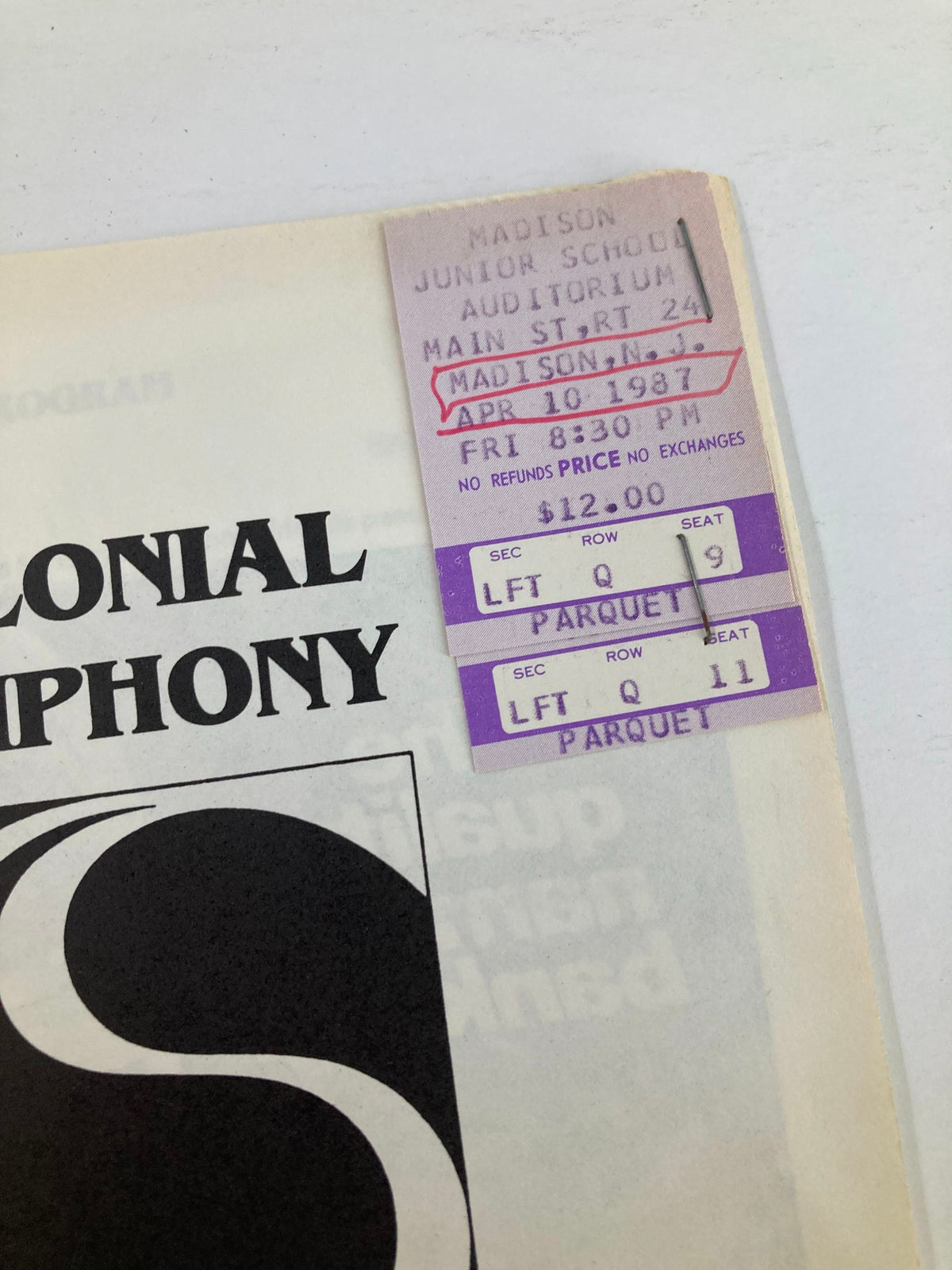 Close-up of the ticket from the 1987 Colonial Symphony performance at Madison Junior School Auditorium, highlighting seat and pricing information.