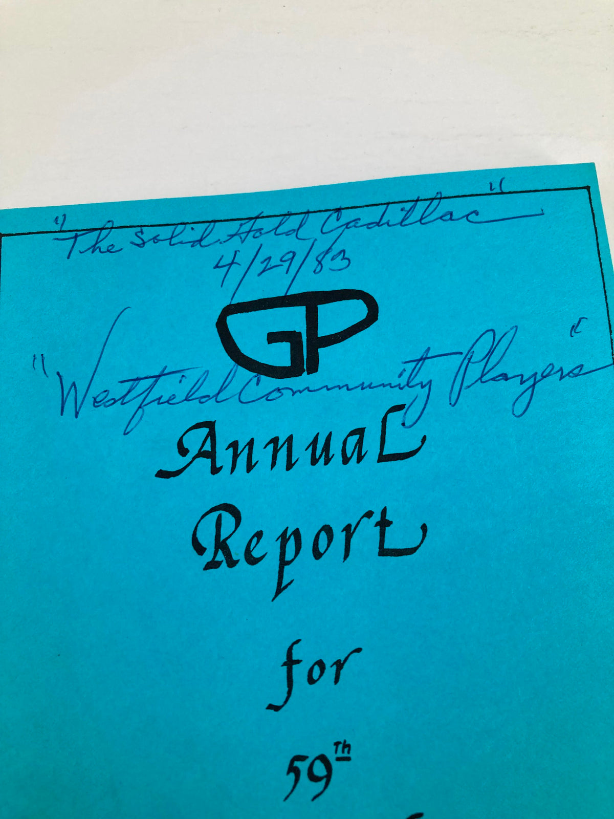 Close-up view of the cover of the 1983 program for 'The Solid Gold Cadillac' by Westfield Community Players, highlighting handwritten notes.