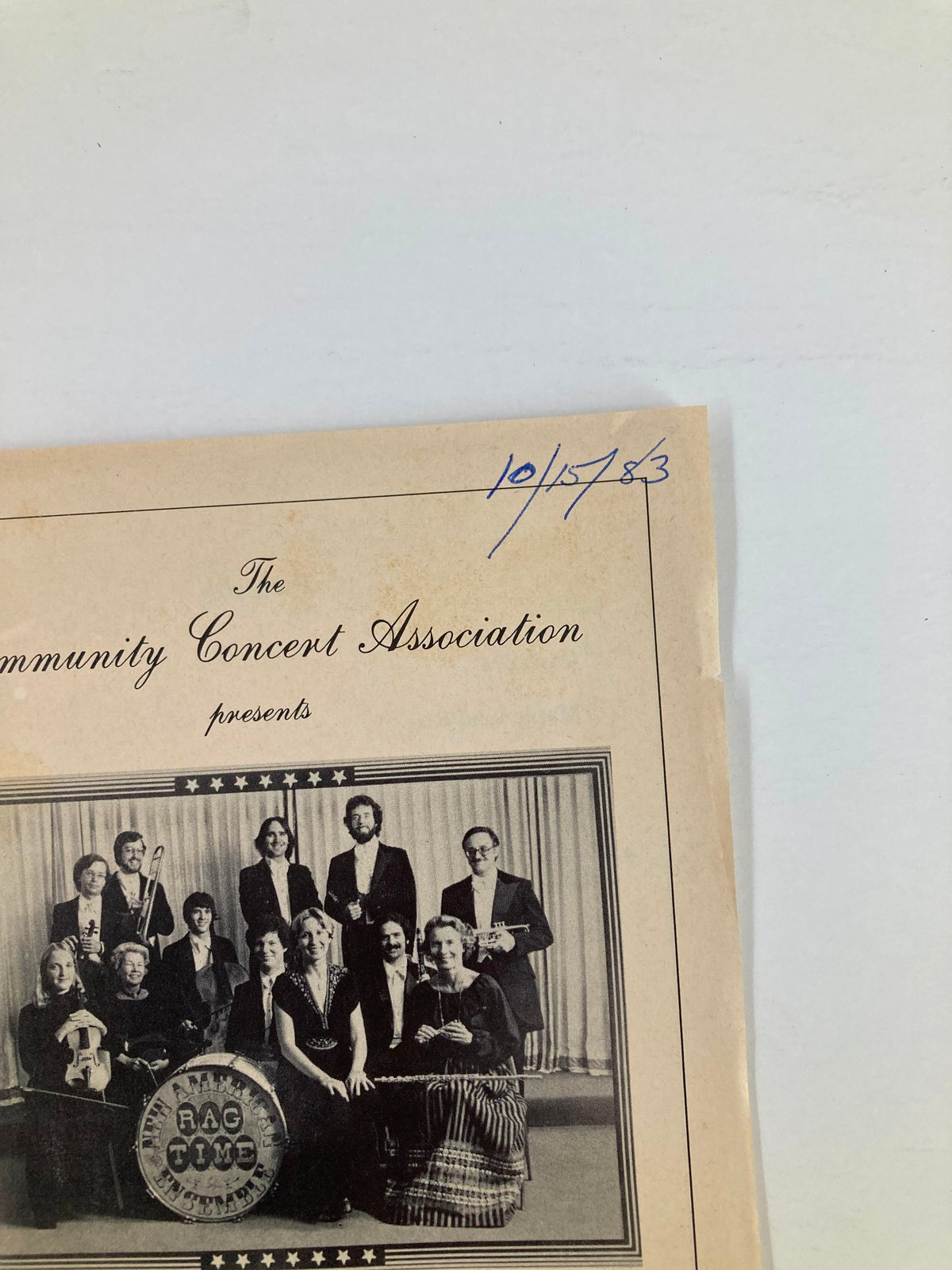 Close-up of the 1983 Program for the Community Concert Association featuring The New American Ragtime Ensemble, highlighting the date written as 10/15/83.