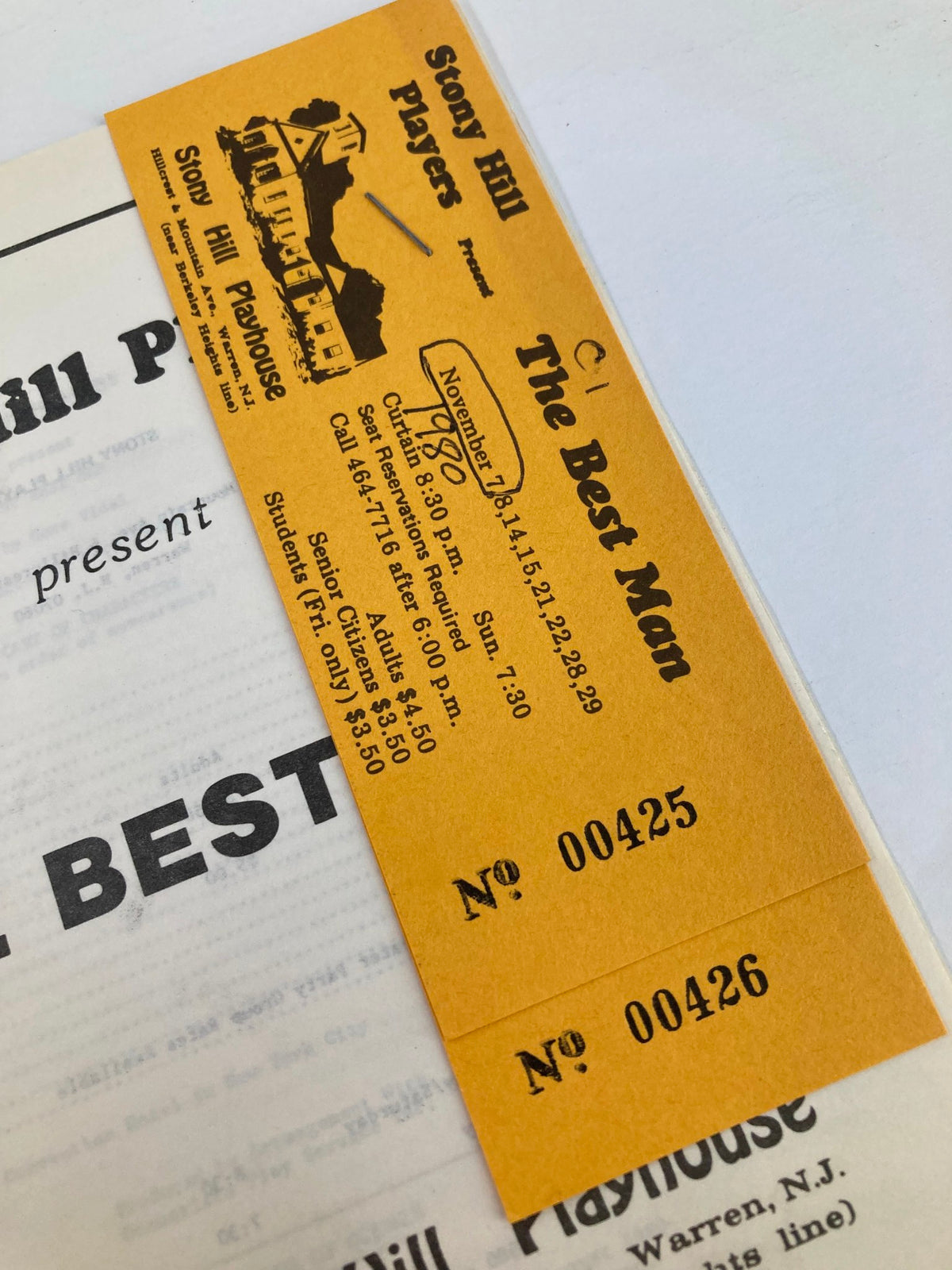 Close-up of the 1980 Stony Hill Players program for The Best Man by Gore Vidal, showing ticket stubs and event details.