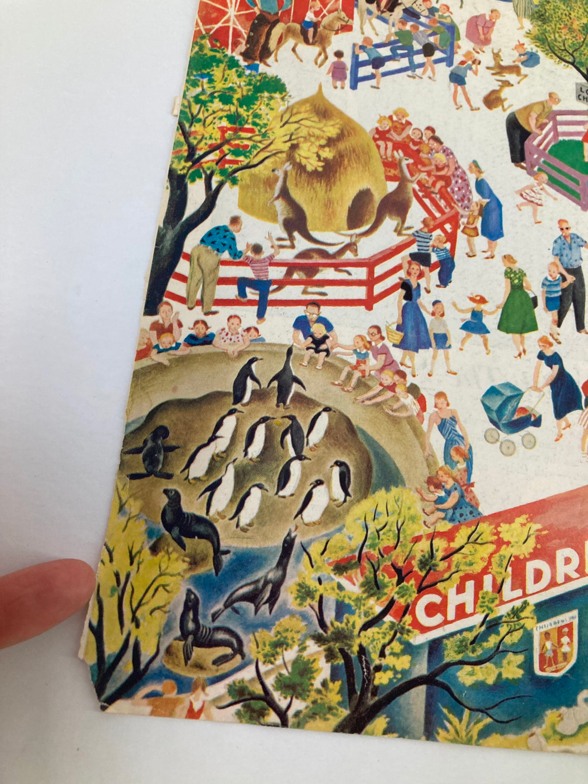 Close-up view of The Saturday Evening Post April 5, 1958 cover highlighting zoo animals like seals and penguins, surrounded by families and children enjoying the scene.