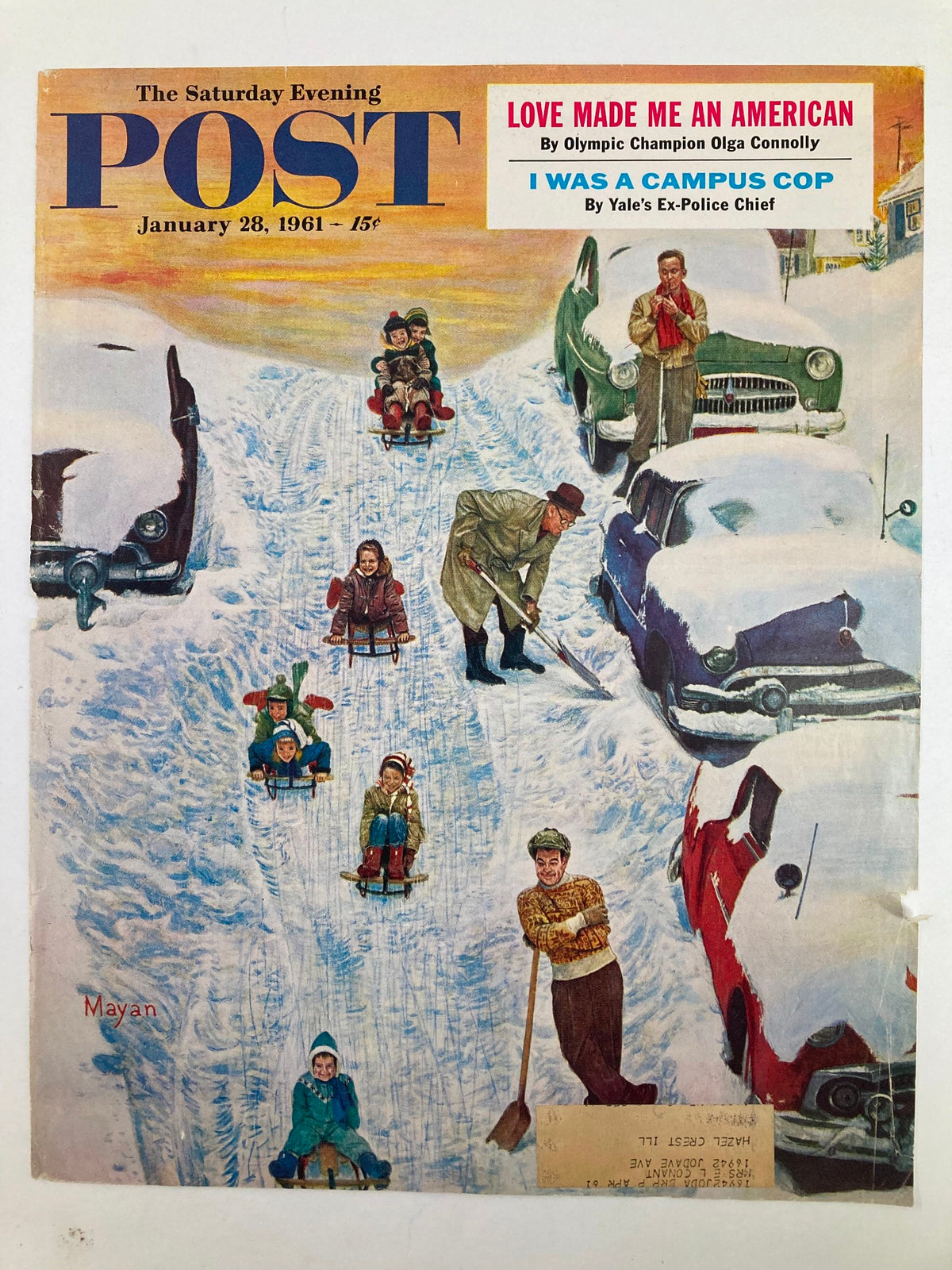Cover of The Saturday Evening Post January 28, 1961, titled 'I Was A Campus Cop', showcasing a snowy landscape with families enjoying sledding and parked vintage vehicles.