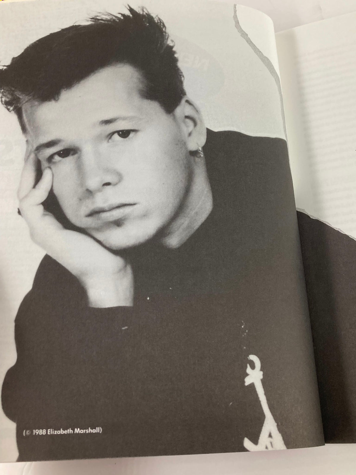 1988 The Official Autobiography Our Story New Kids On The Block - A black-and-white image of a young artist in a thoughtful pose, reflecting on his formative years in the music industry.
