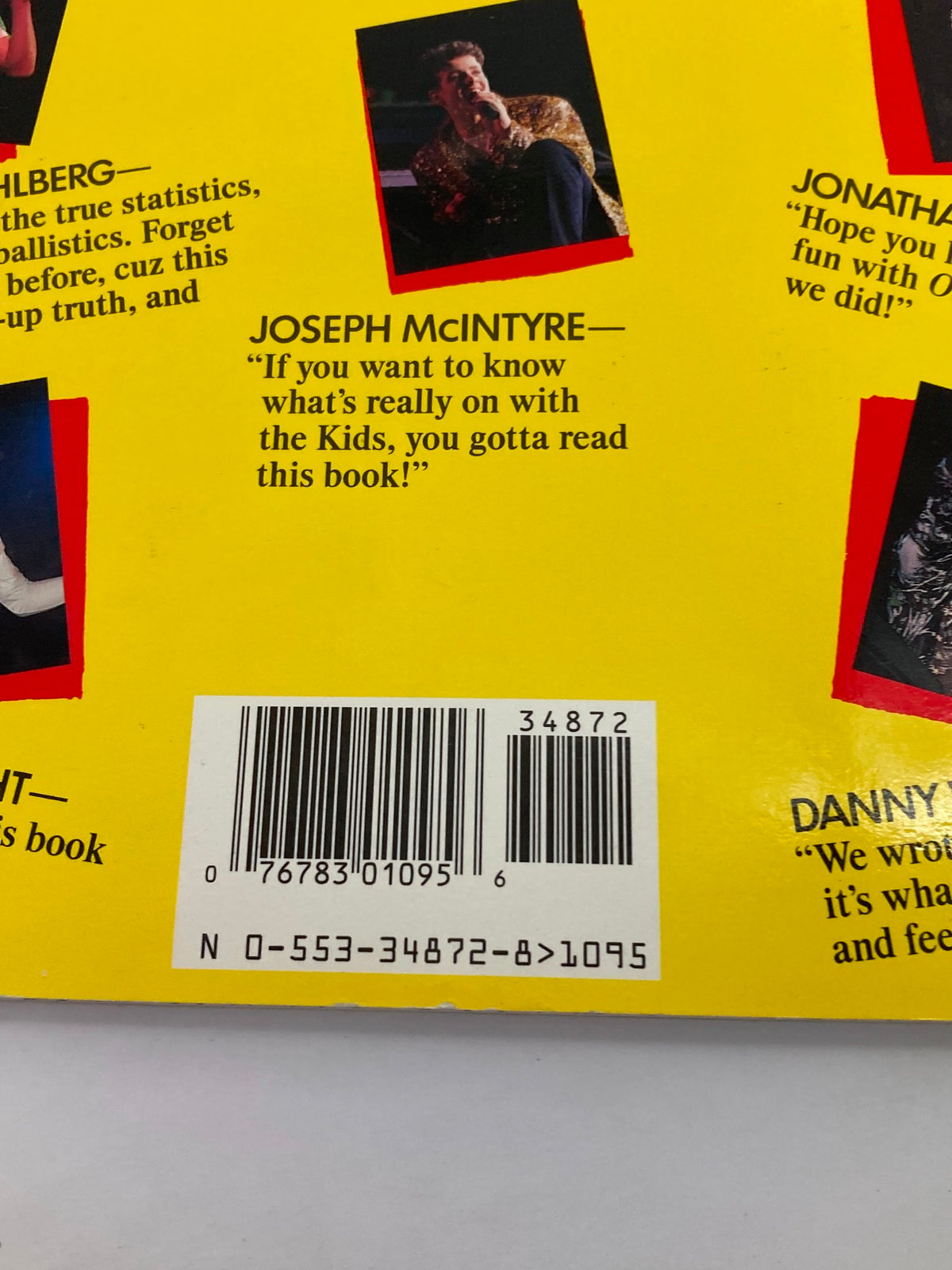 A close-up of the back cover details from '1988 The Official Autobiography Our Story New Kids On The Block', showcasing quotes from band members and a barcode, enhancing the nostalgic appeal of the publication.