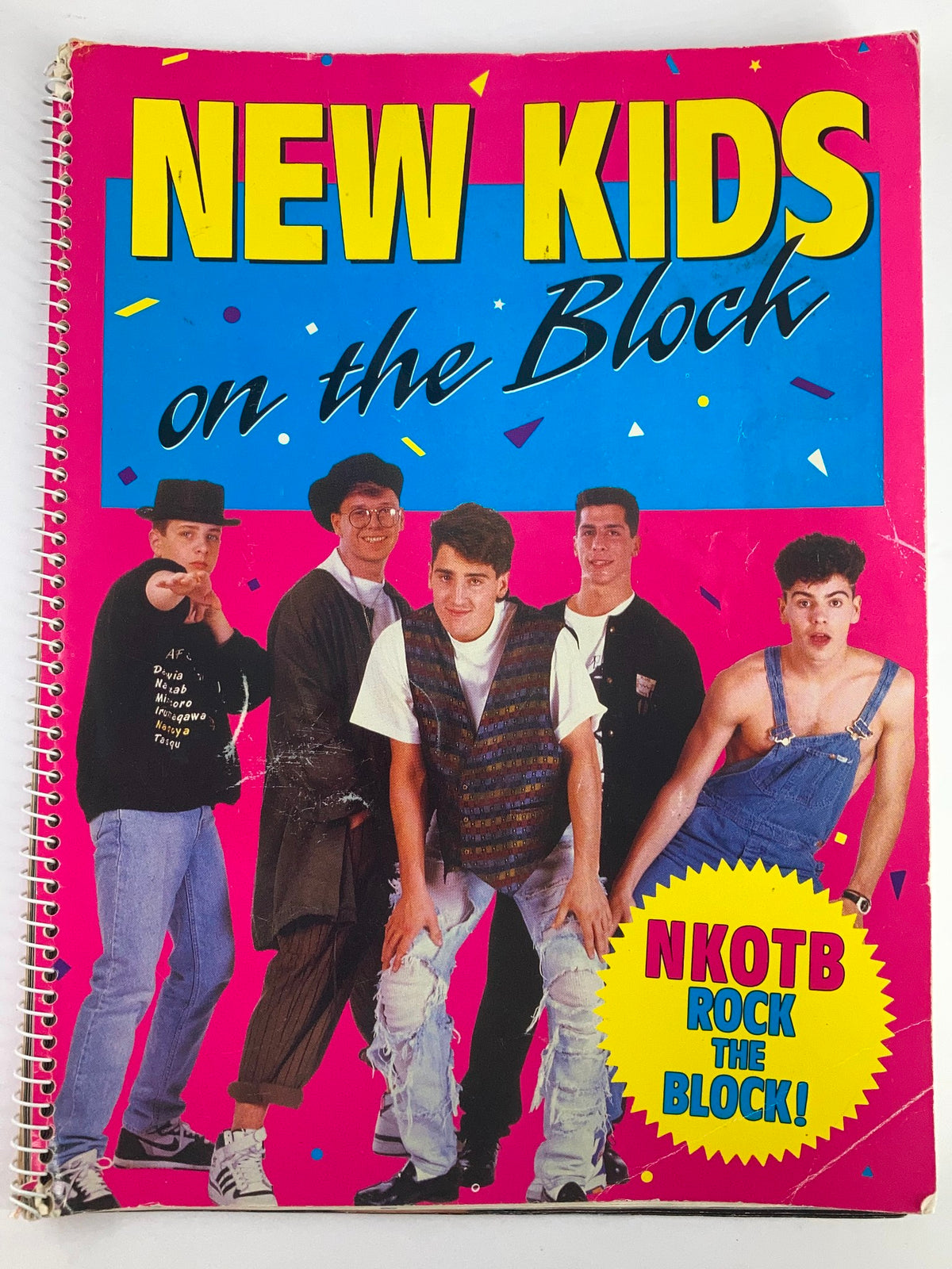 Cover of the 1990 Publications International, Ltd. Presents New Kids On The Block booklet featuring the band in colorful outfits and a vibrant background, highlighting their iconic style and appeal.