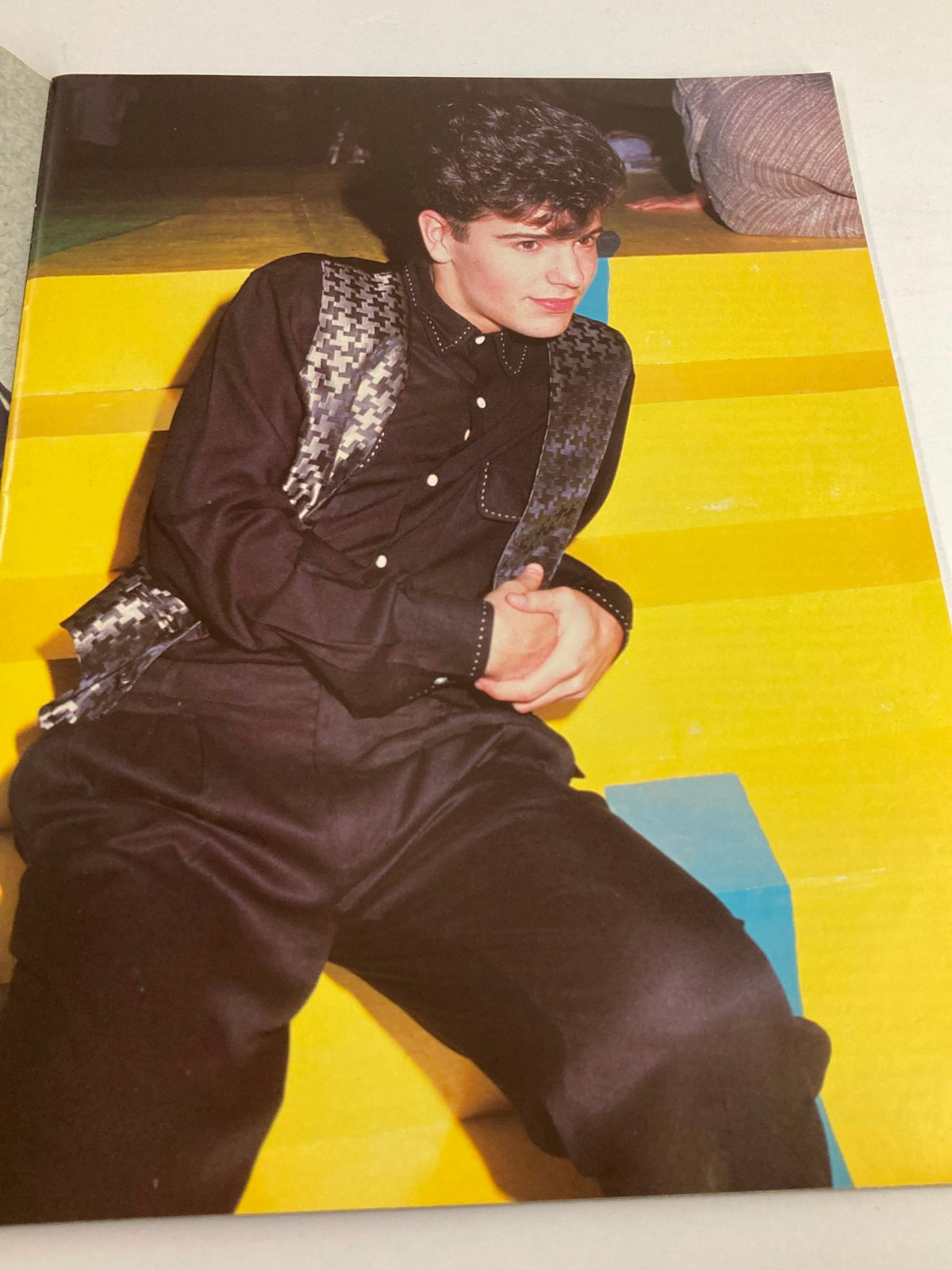 1989 New Kids On The Block They'll Be Lovin' You Forever - A stylish young man reclining in a vibrant, colorful setting evoking the fashion of the late 80s.