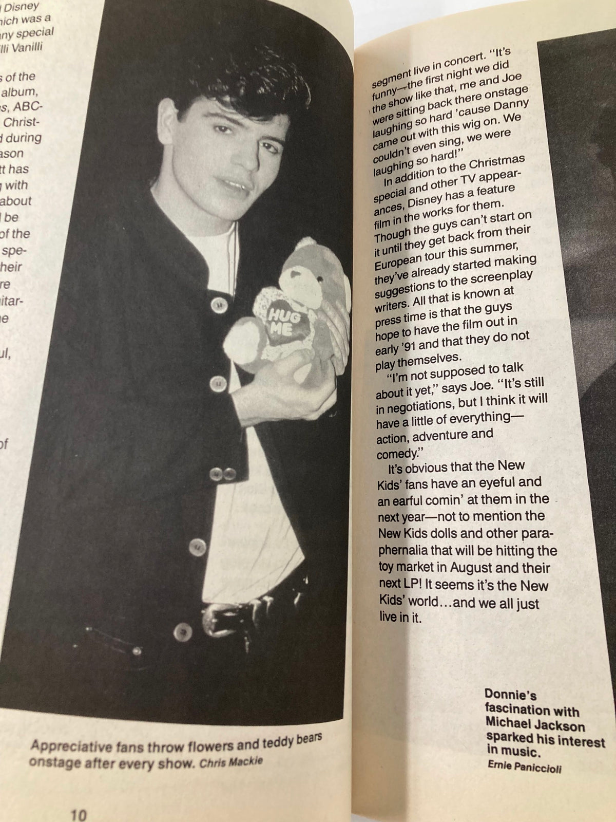 1990 New Kids on The Block Scrapbook by Anne M. Raso featuring Donnie Wahlberg holding a teddy bear on stage during a concert.