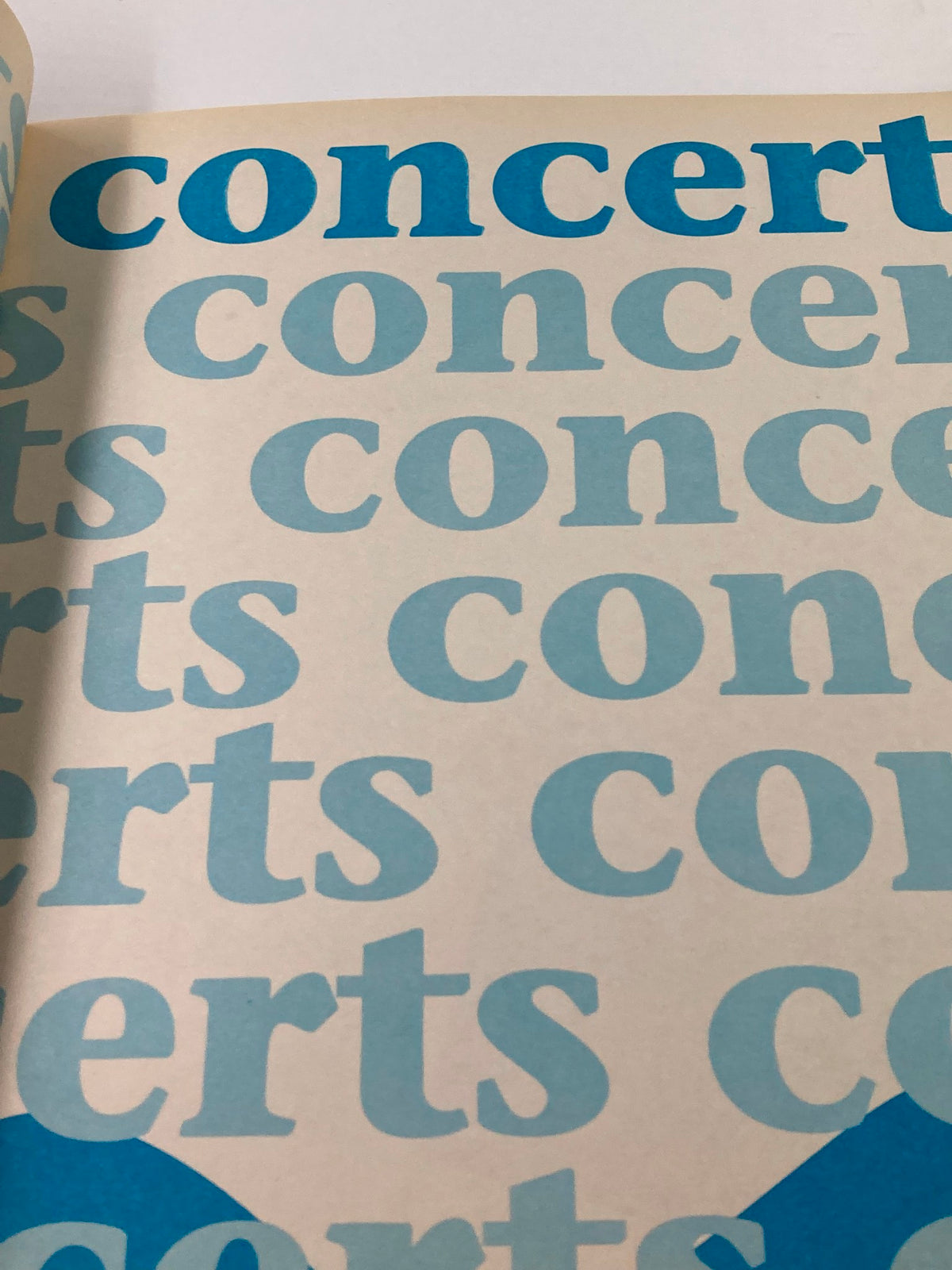 Image from the 1989 Official New Kids on The Block Bonus Scrapbook displaying a page filled with the word 'concerts' in large blue text.