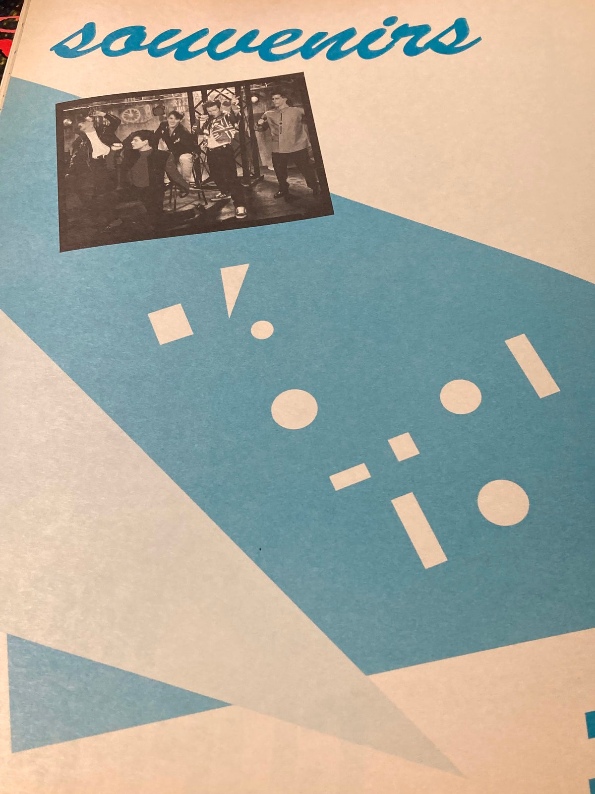 Cover of the 1989 Official New Kids on The Block Bonus Scrapbook featuring a blue geometric design and a black and white photo of the band.